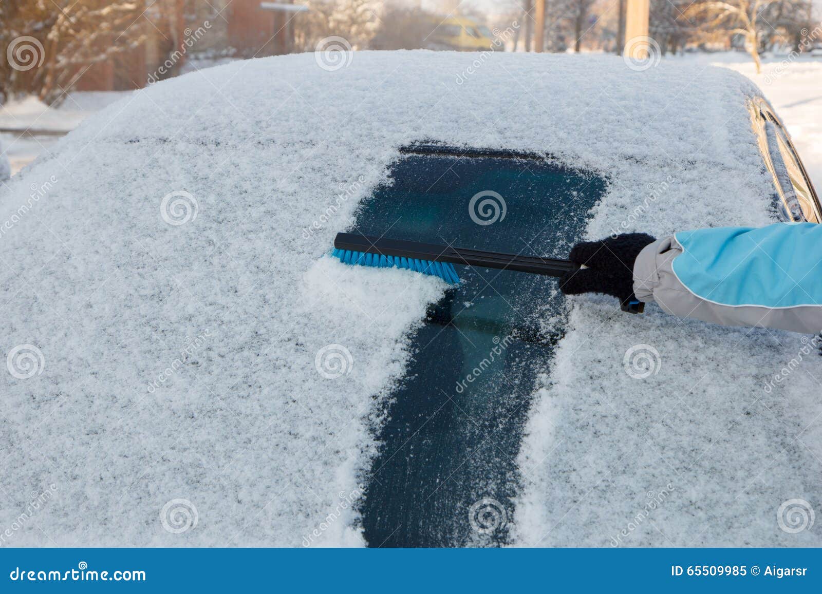 Clearing snow off a car stock image. Image of brush, freeze 65509985
