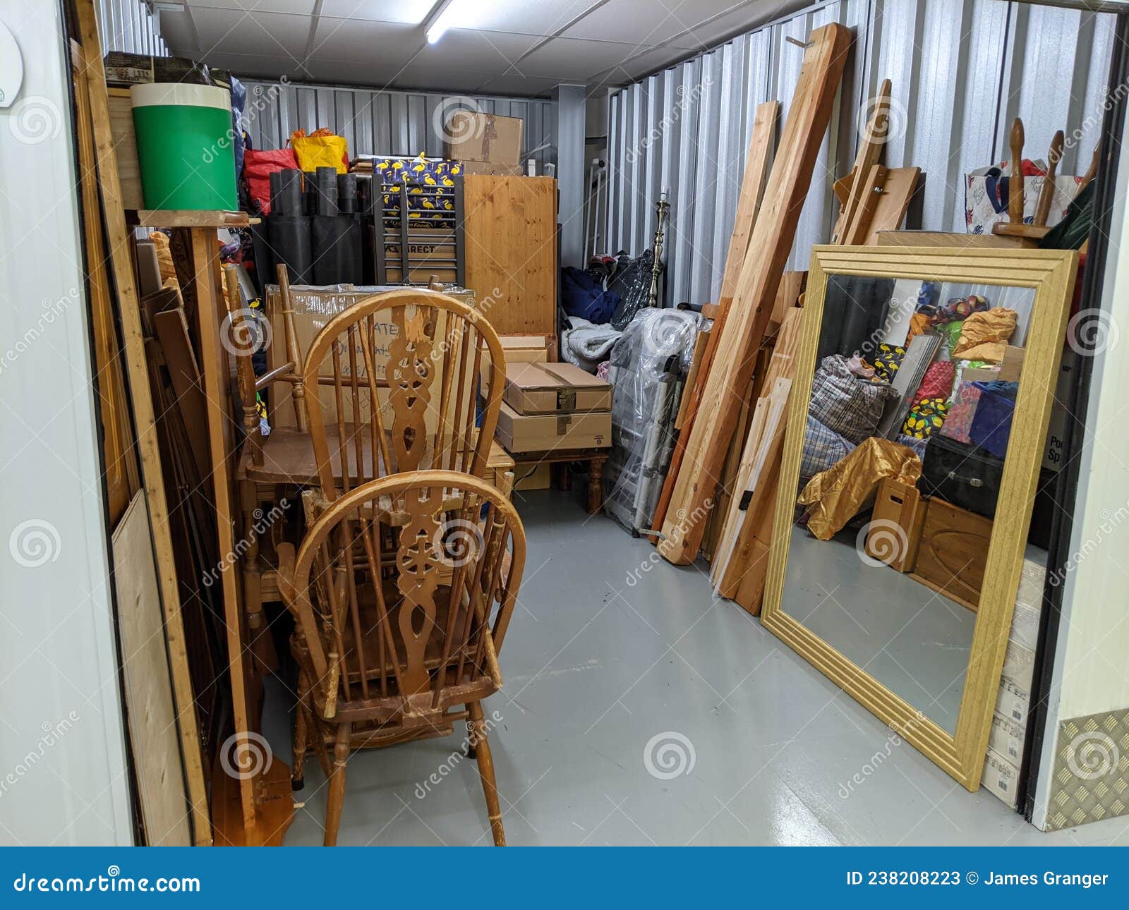 clearing a storage unit full with household furniture