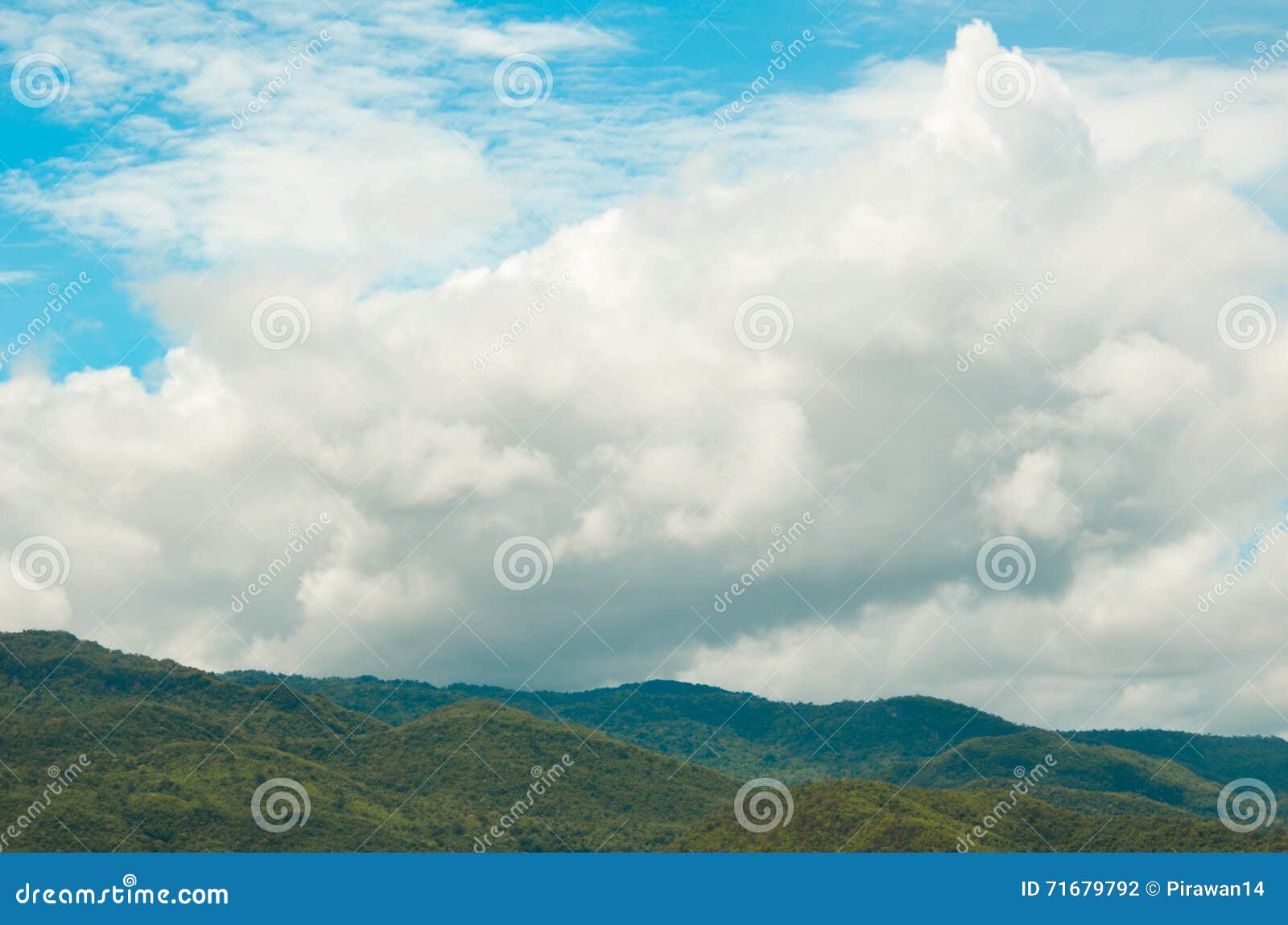 Clearly and hazy sky with white and gray clouds over mountains