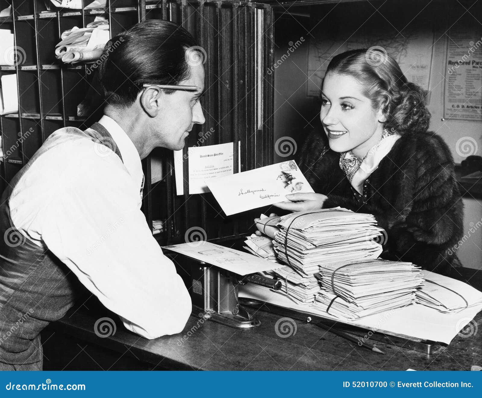 clerk with woman mailing letter