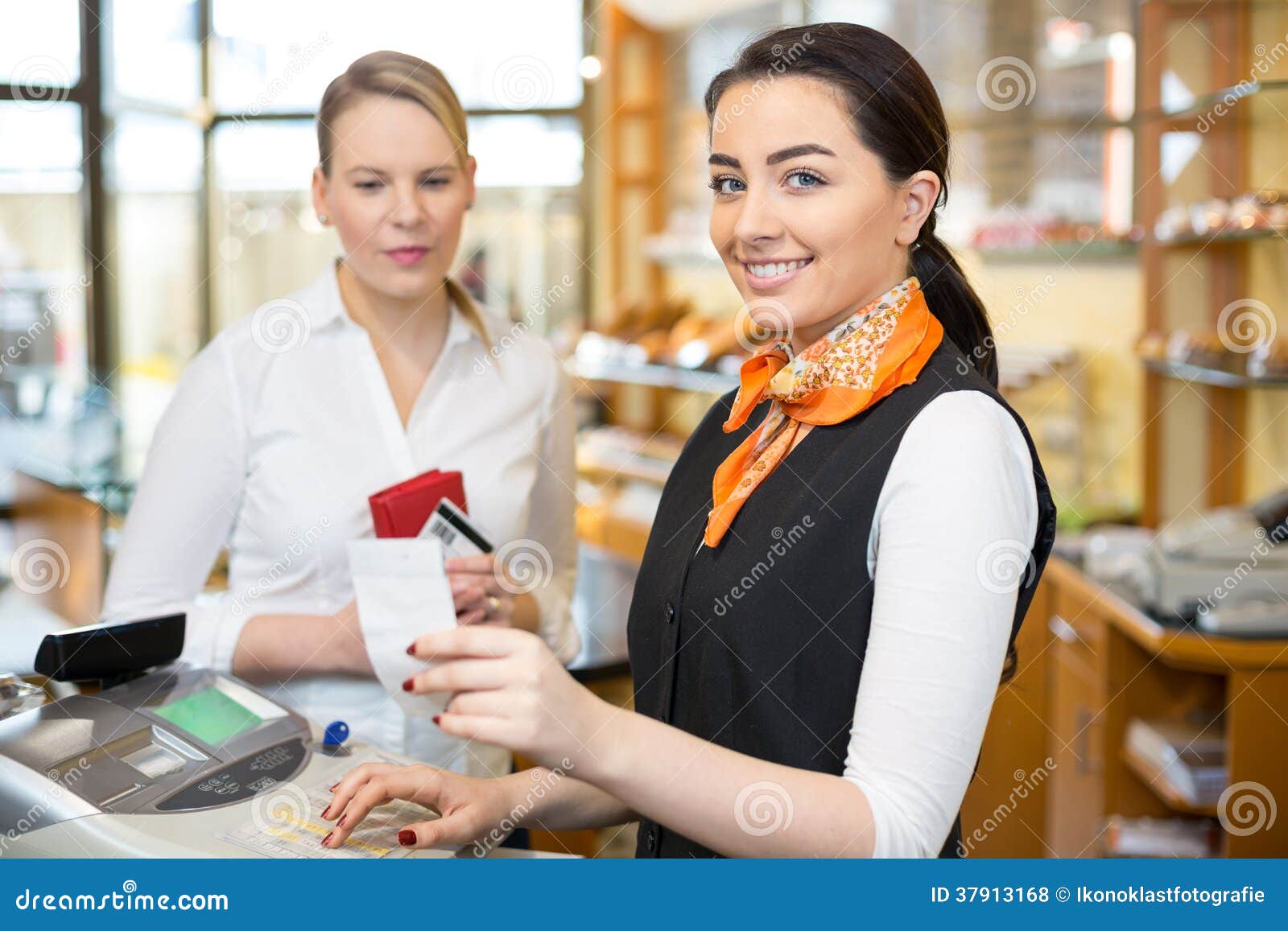 client at shop paying at cash register