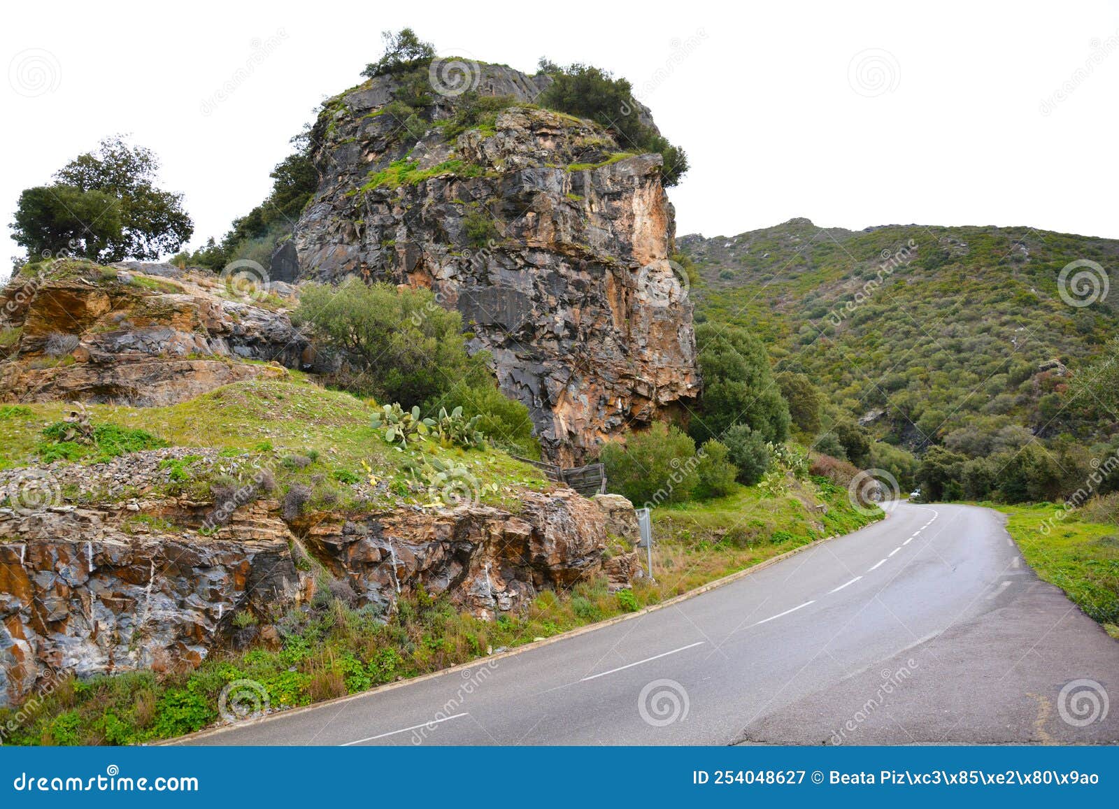 cliff over a road in patrimonio, corsica