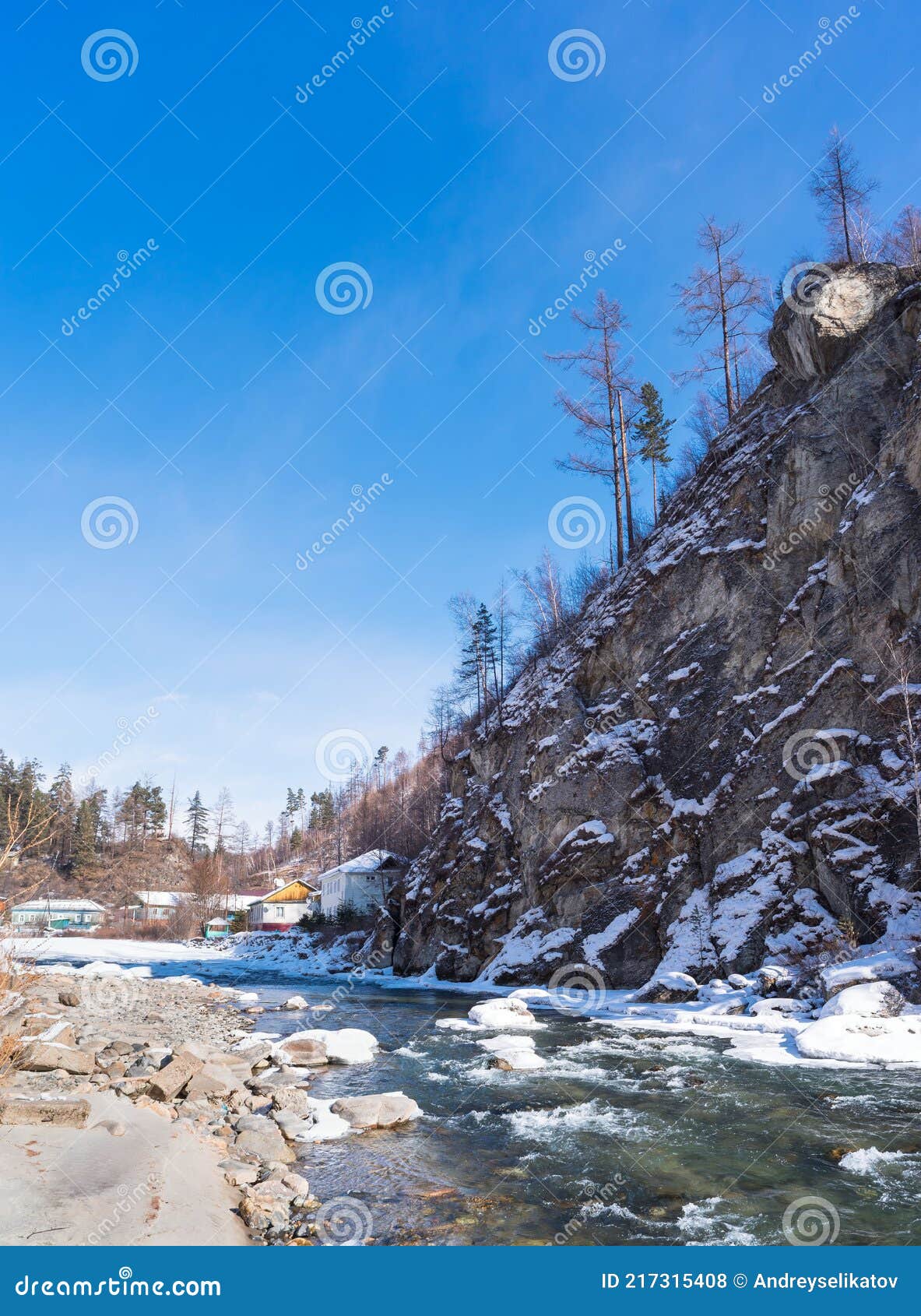 The Cliff Rises Above The Mountain River In Early Spring The Village