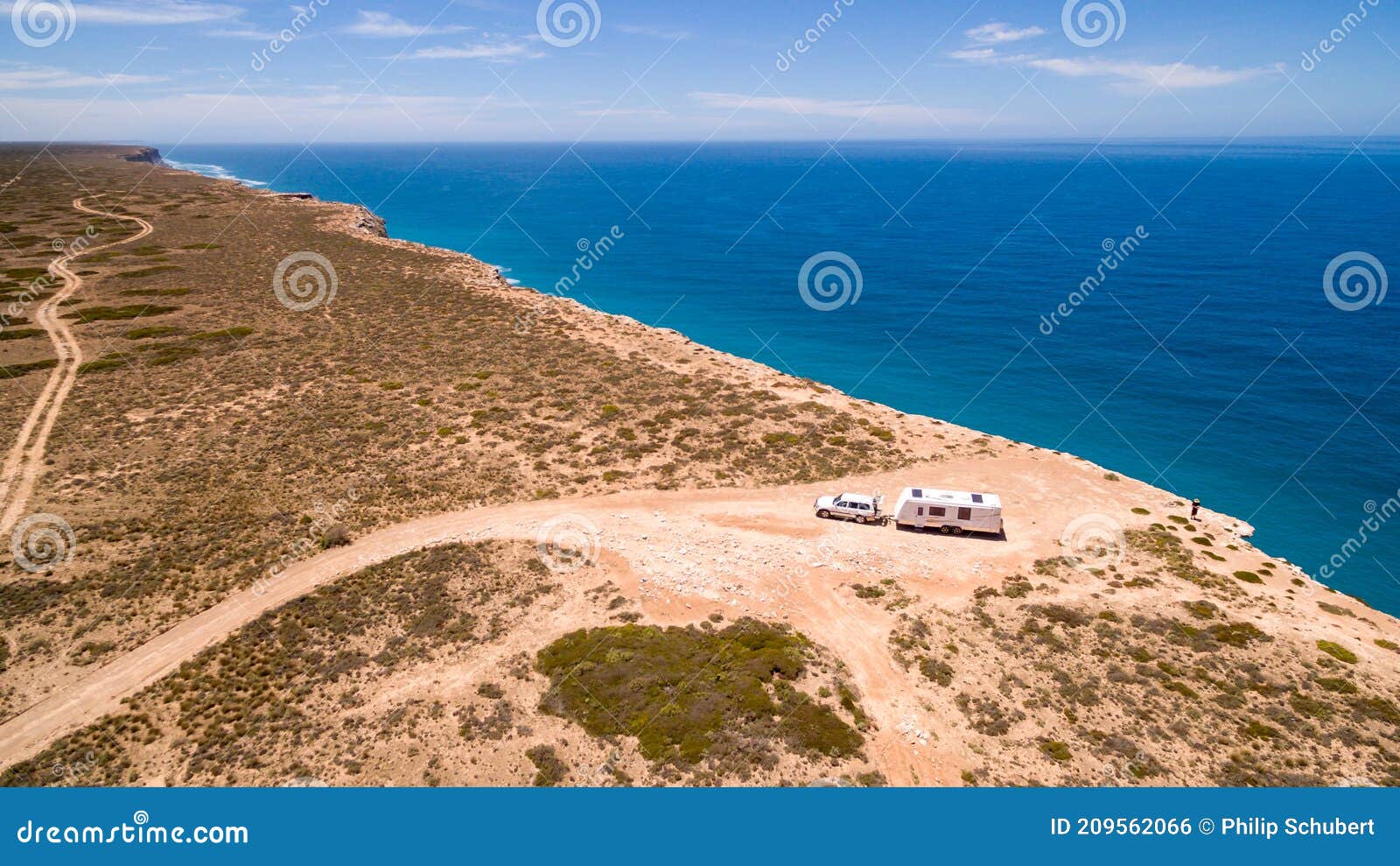 aerial view of four wheel drive vehicle and caravan parked at the great australian bight on the edge of the nullarbor plain