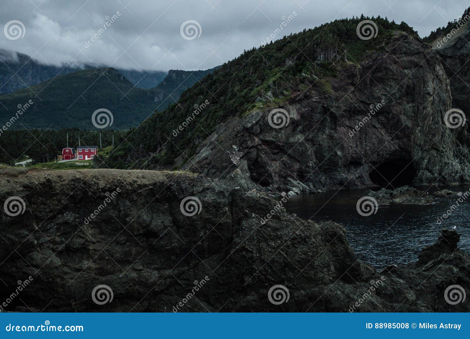 Cliffs and Red House Along a Rugged Coastline at Lark Harbor in Newfoundland Stock Photo Image