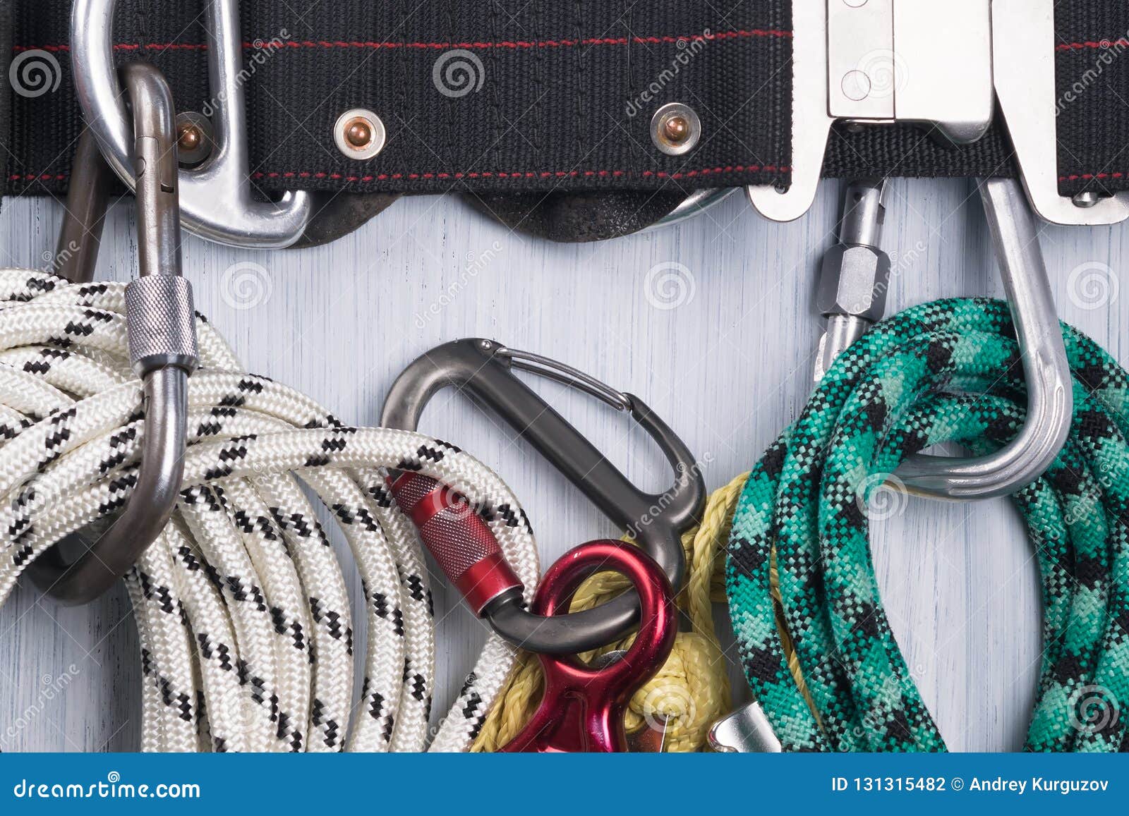 Climber`s Belt with Different Ropes and Carbines for Insurance Lie on a ...