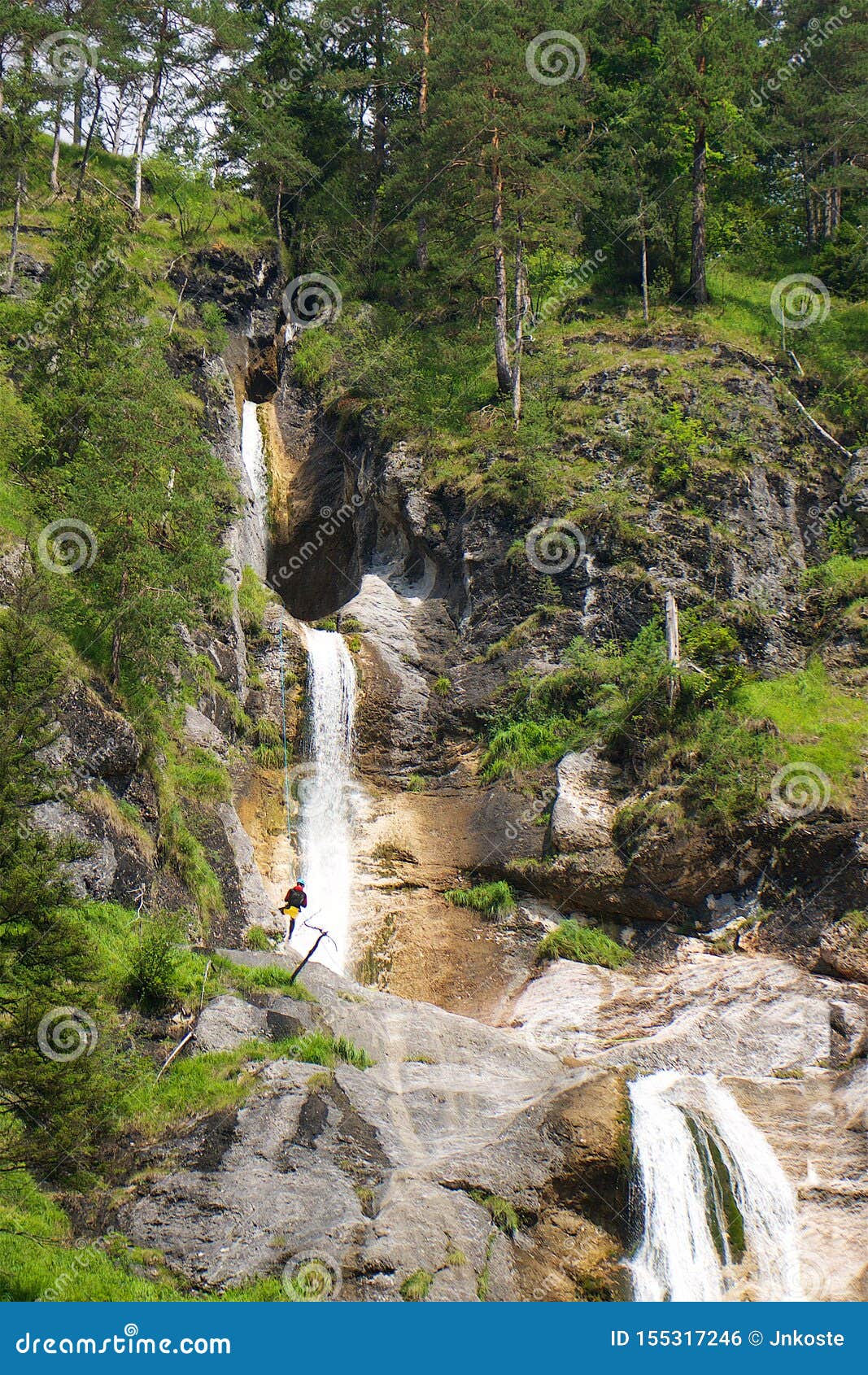 climber in the waterfall in almbachklamm pass in berchtesgaden