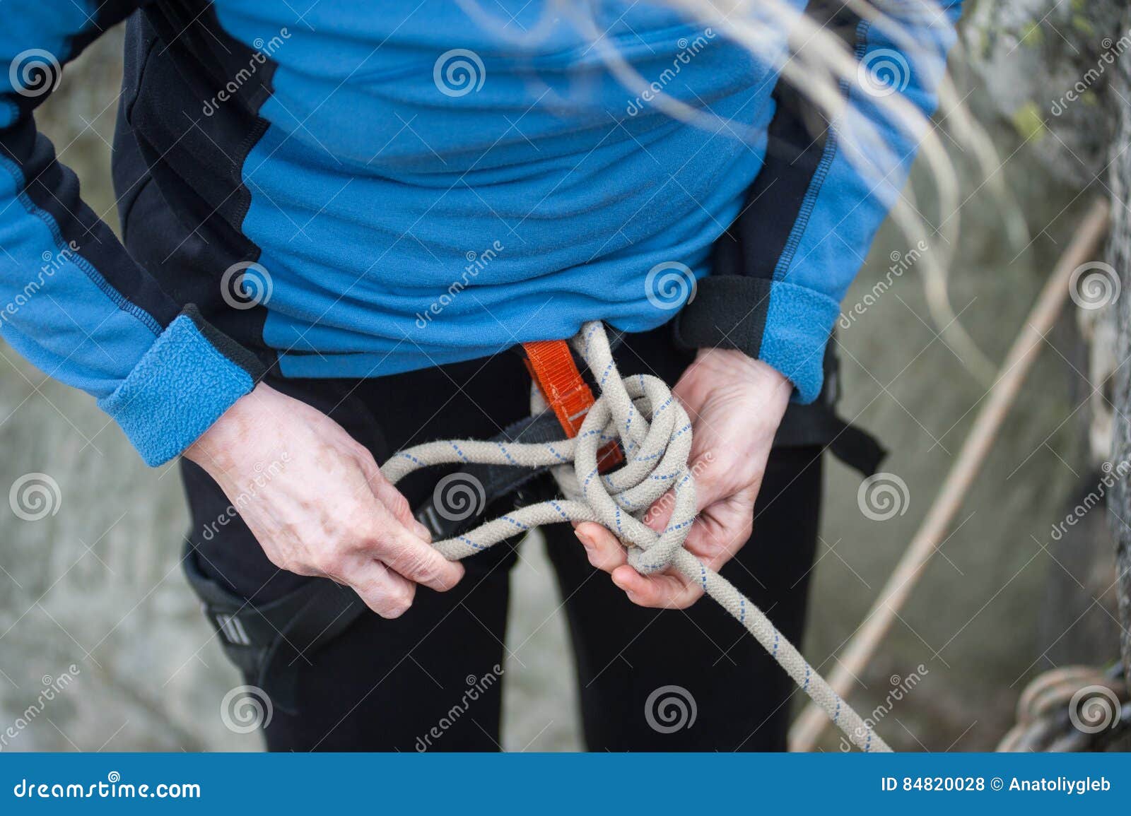 Climber Woman in Safety Harness Tying Rope in Bowline Knot Stock