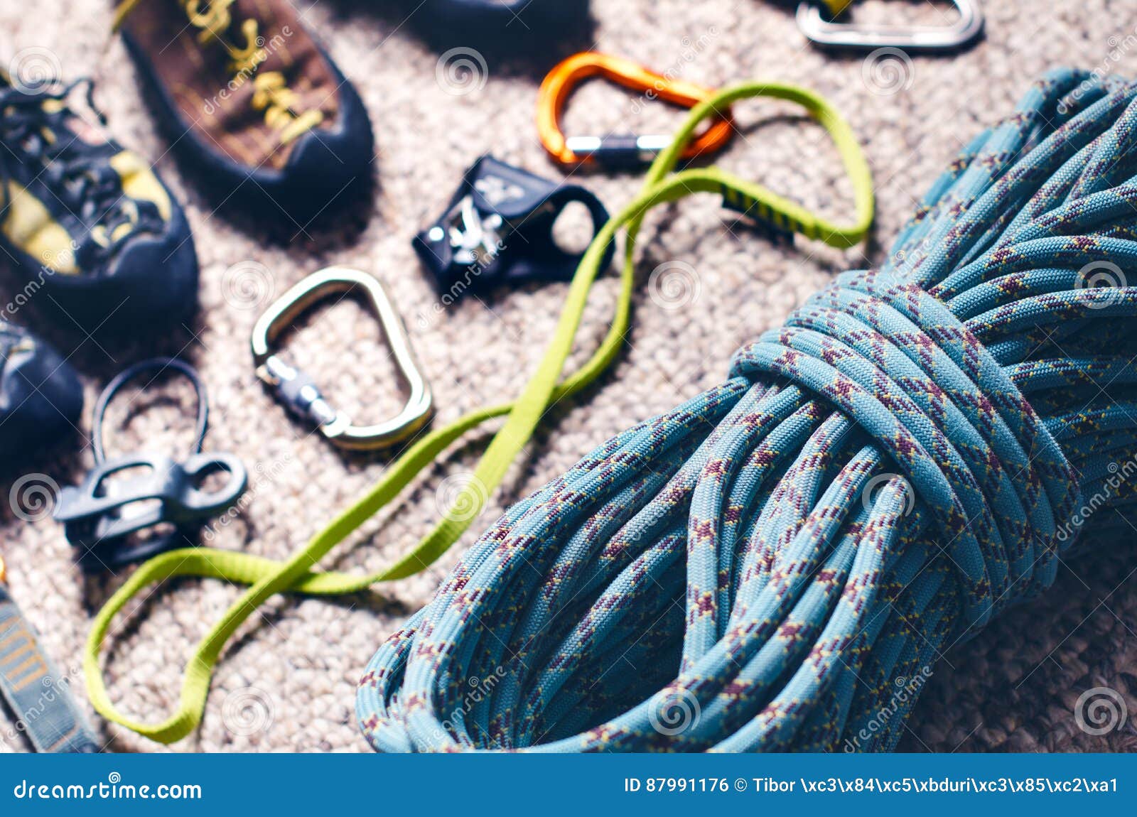 Climbing and Mountaineering Equipment on a Carpet. Shoes, Carbine, Rope ...