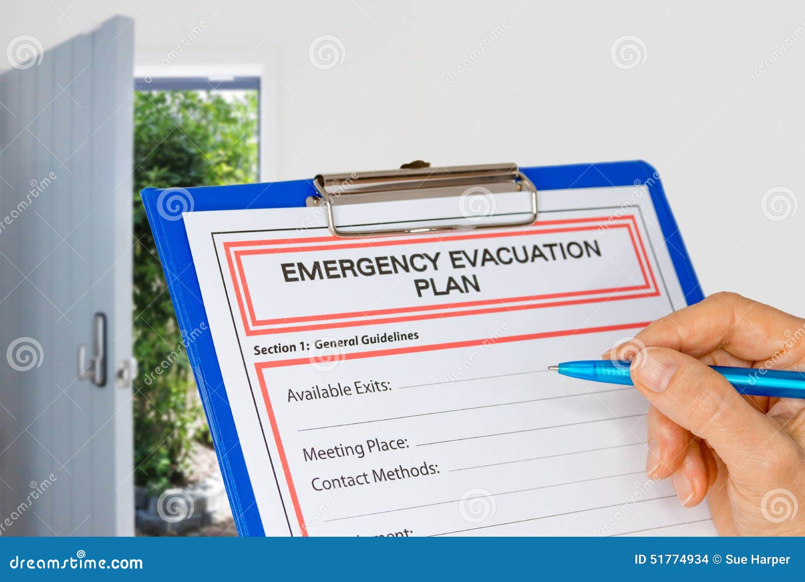 Clipboard with Emergency Evacuation Plan beside Exit Door Stock Photo