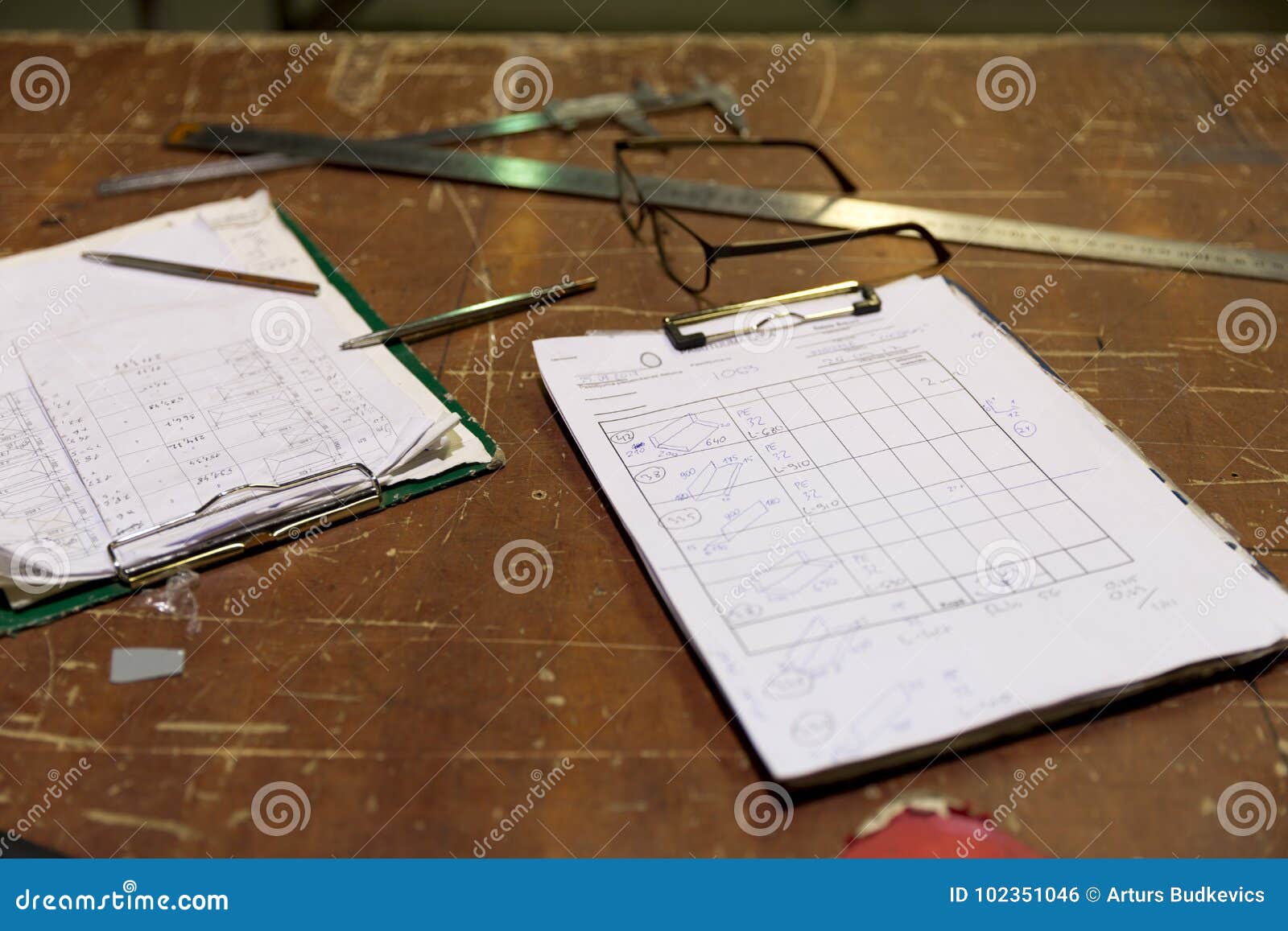 clipboards with order notes on workshop table