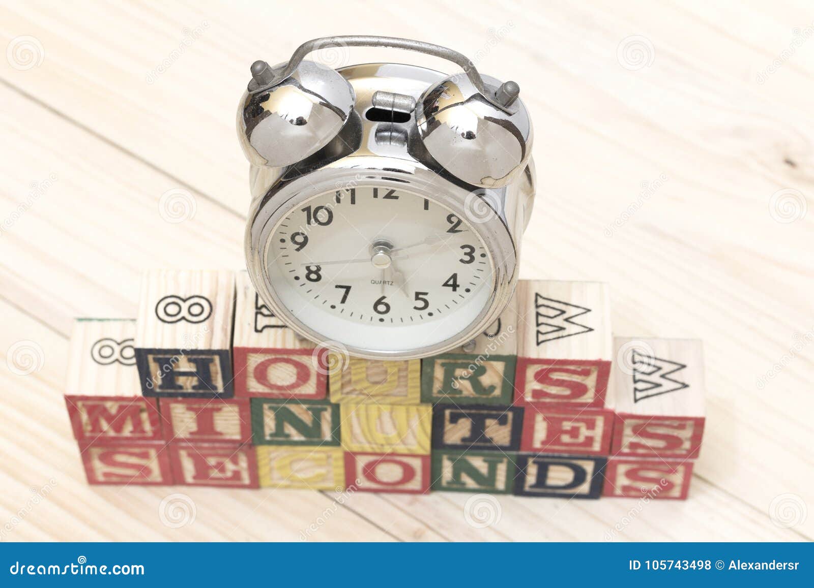 Clock With Wood Cubes On Wooden Table Words Hours Minutes