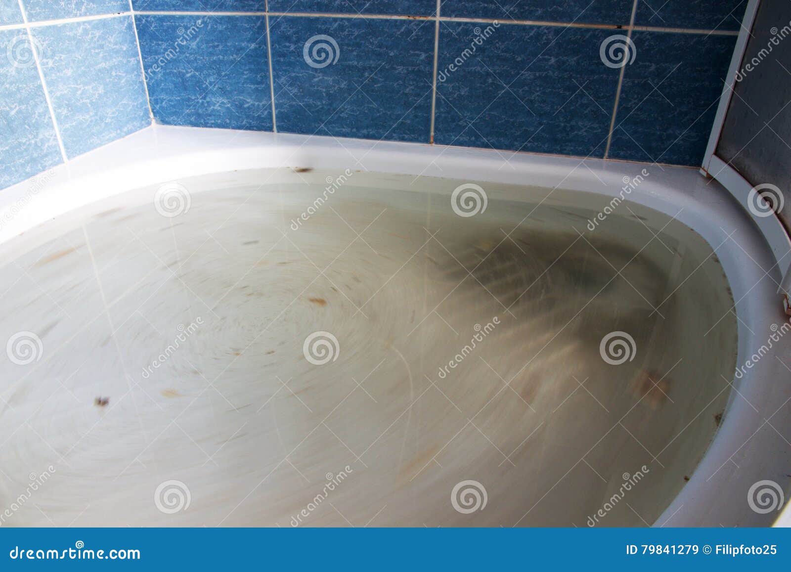 Teenager Girl Plunging The Clogged Bathtub Stock Photo - Download