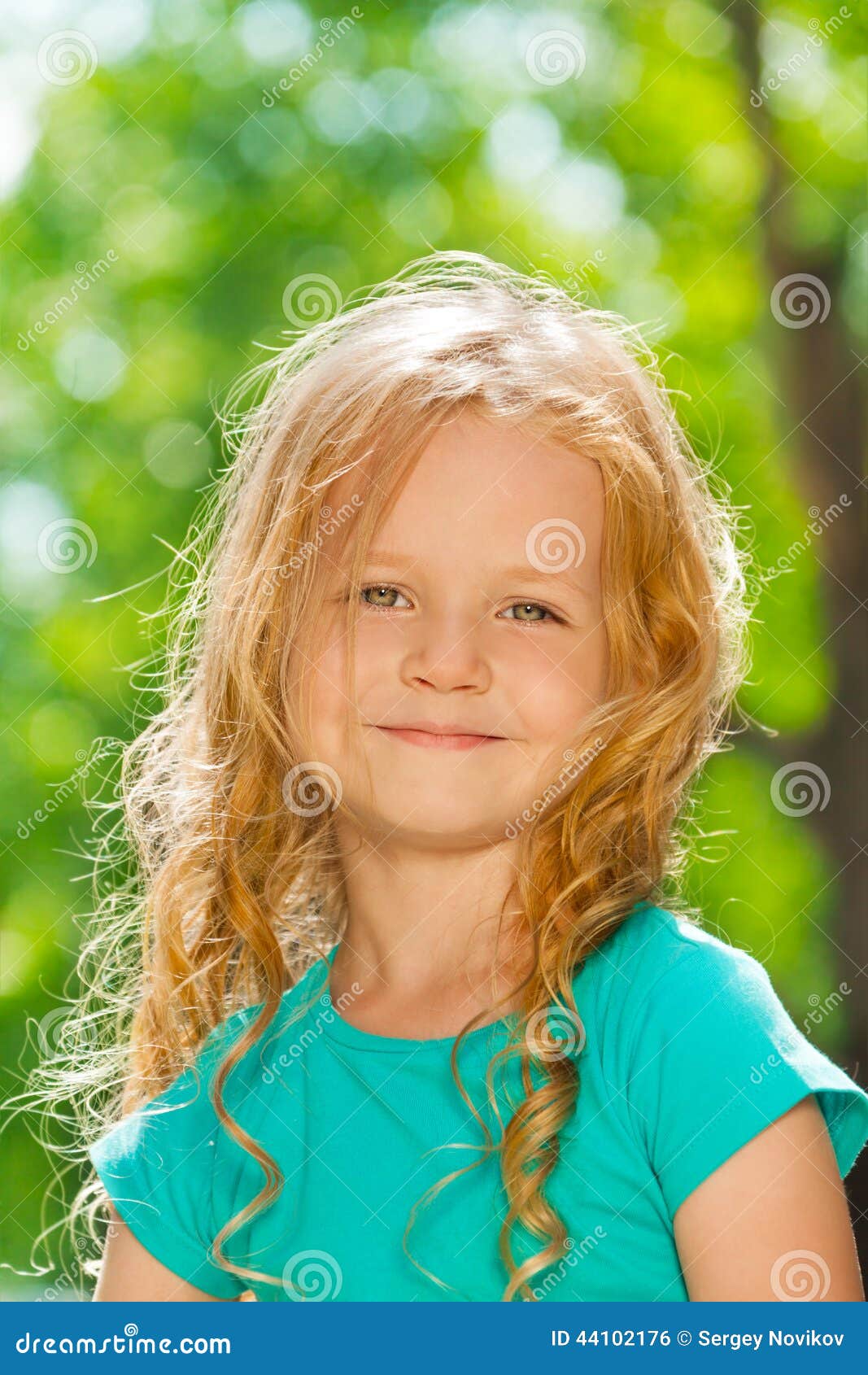 Close Portrait Of Curly Happy Little Girl Outside Stock Photo
