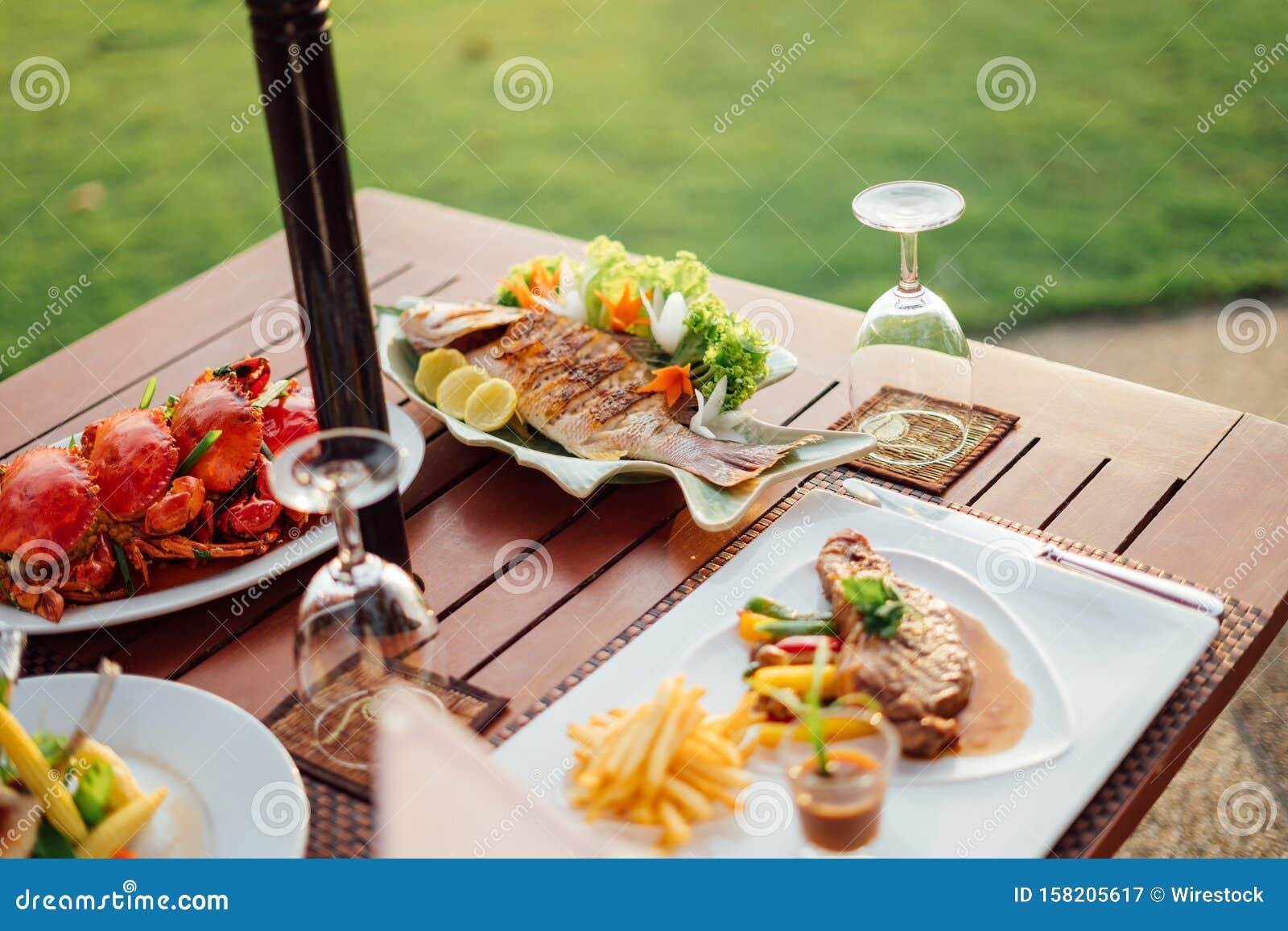 Close Shot Of Dish With Fish Near Crabs On A Wooden Table