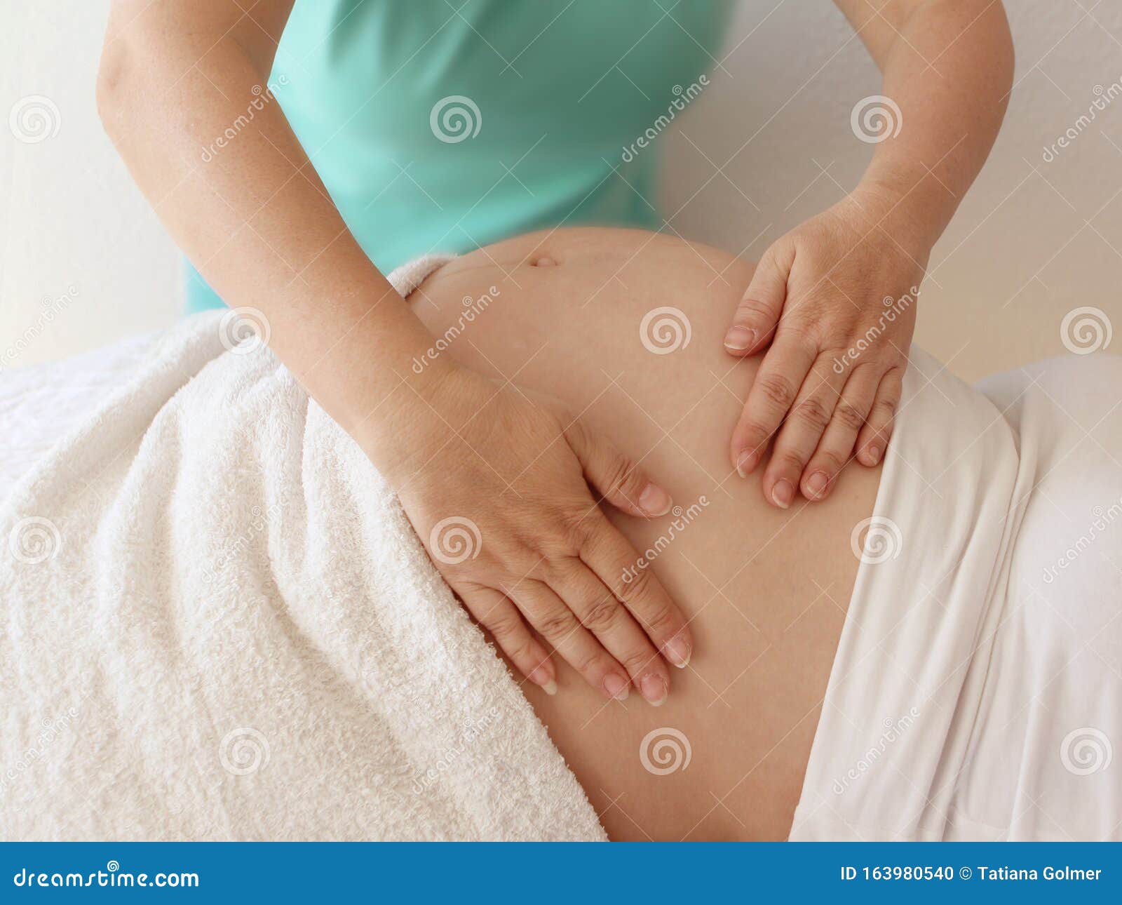 Close To The Female Hands Of A Massage Therapist Makes A Light