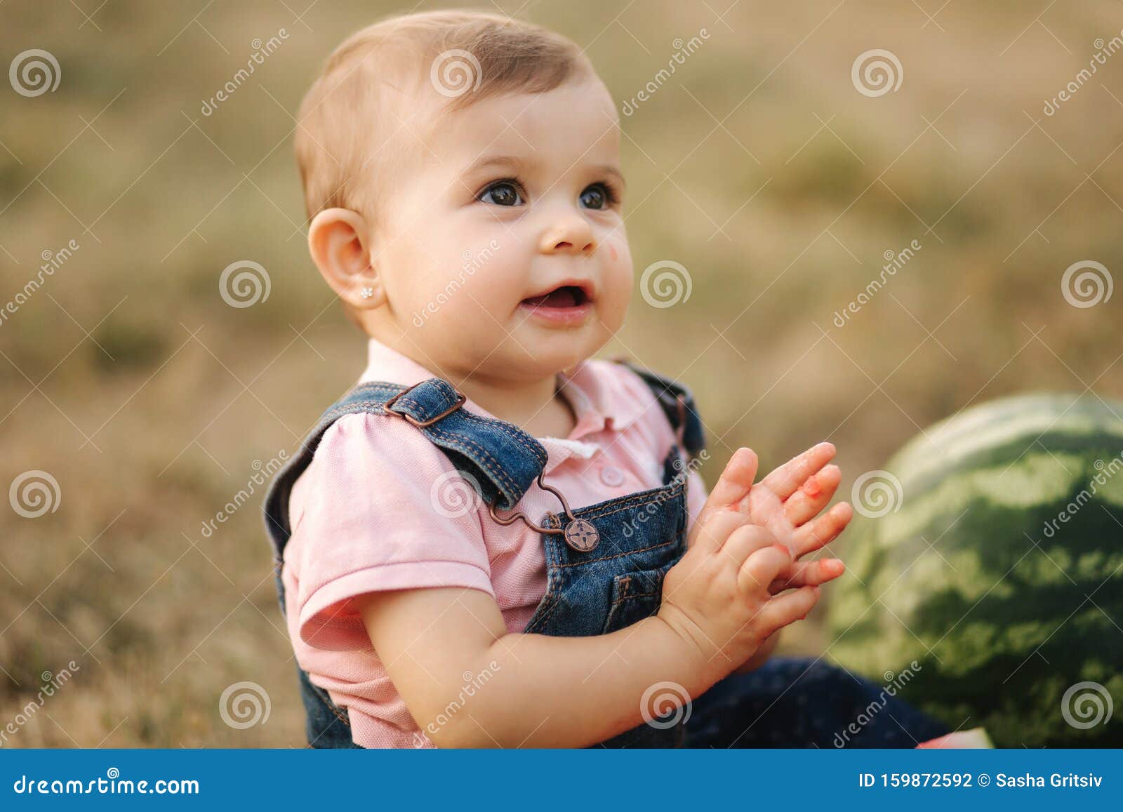 Close Up Of Adorable Baby Girl Eat Watermelon Stylish Baby In Denim Dress Beautiful Child Eat Fruit Outdoors Stock Photo Image Of Backyard Eating