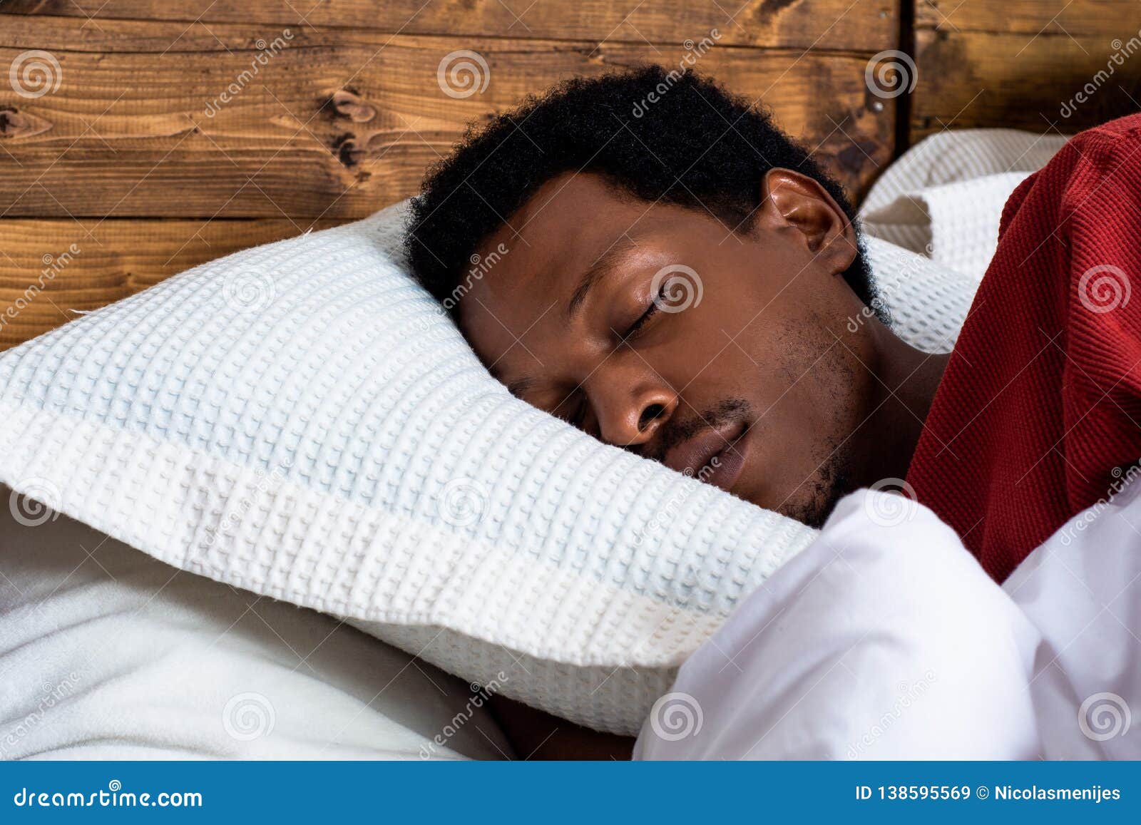 Young man sleeping in bed stock image. Image of indoor 138595569