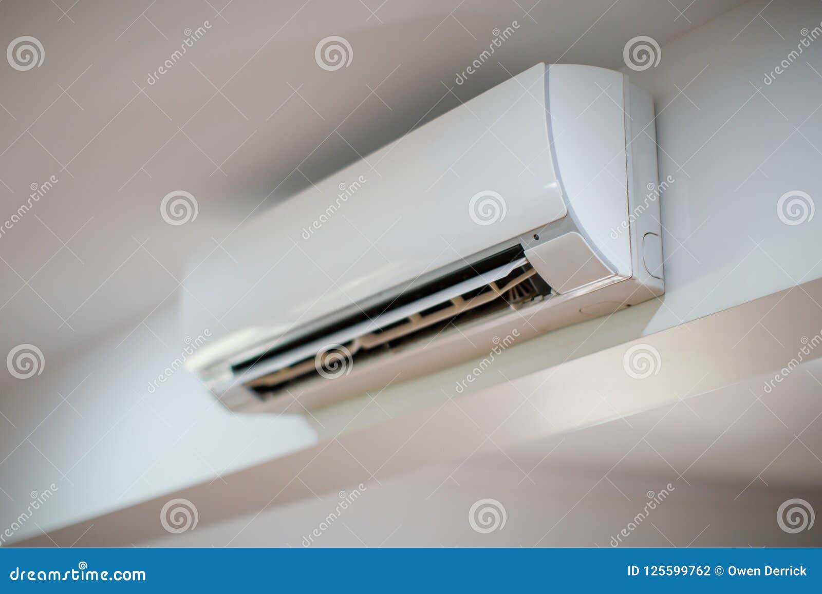 close up of an air conditioner on a white wall