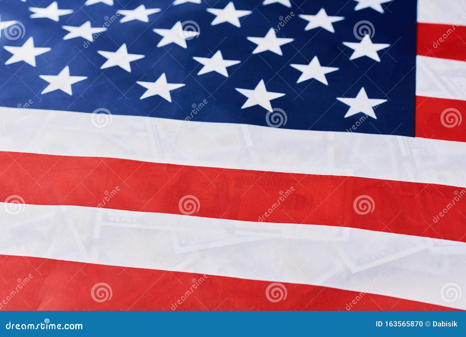Close Up Of American Flag Over Many Usd Dollar Bills Financial Concept close-up-of-american-flag-over-many-usd-dollar-bills-financial-concept