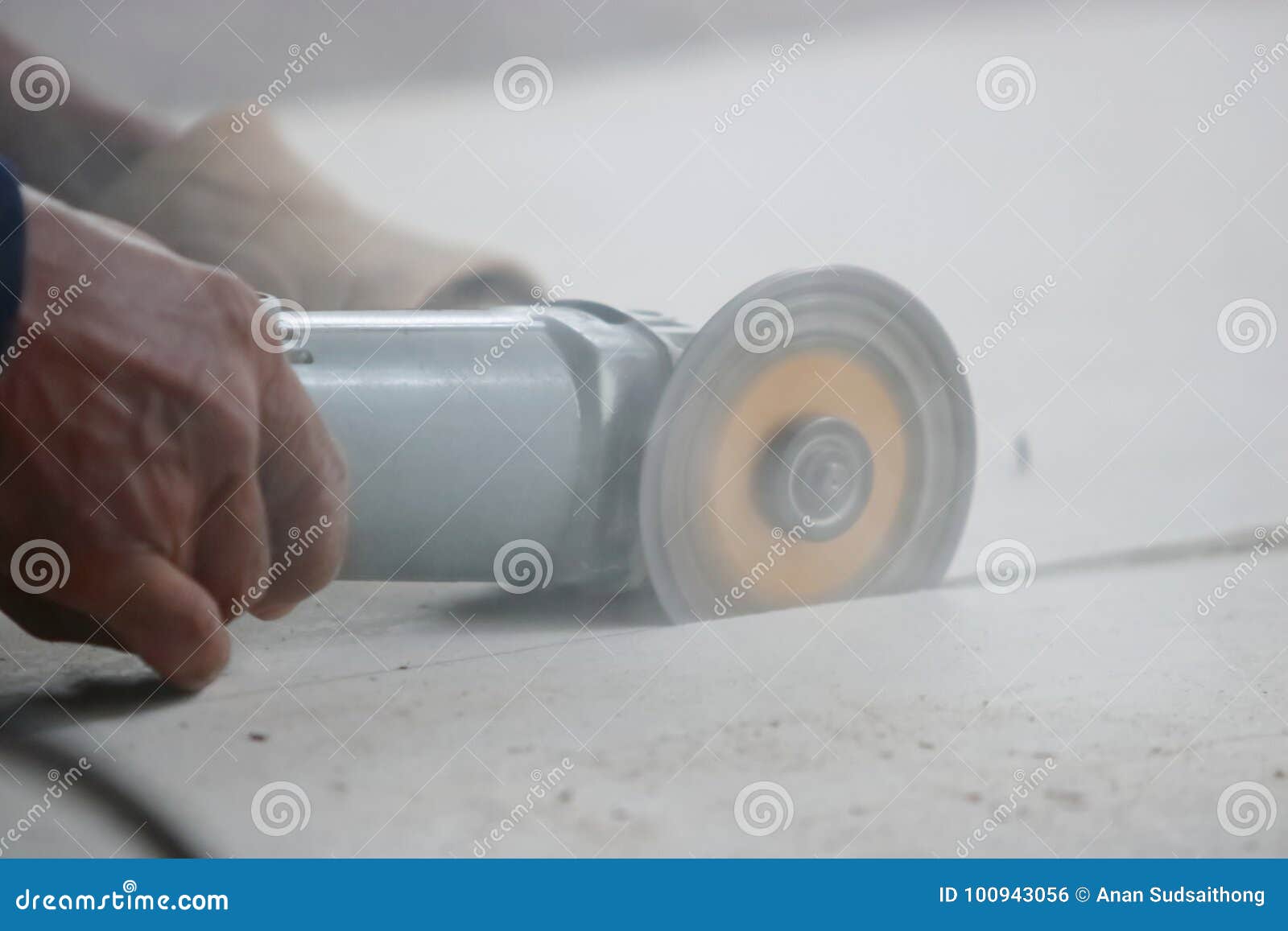 Close Up Angle Grinder Cutting Concrete with Hands of Construction
