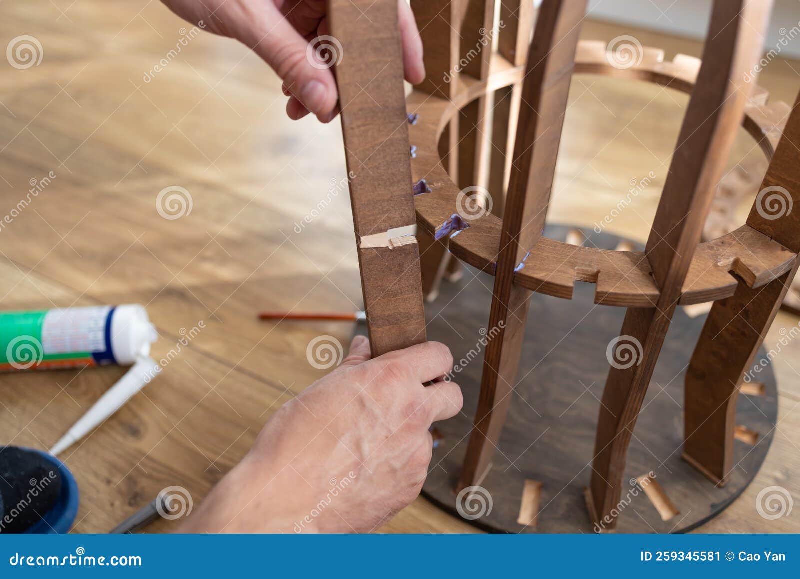 Applying Glue on the Wood. Carpenter at Work Using Glue in His