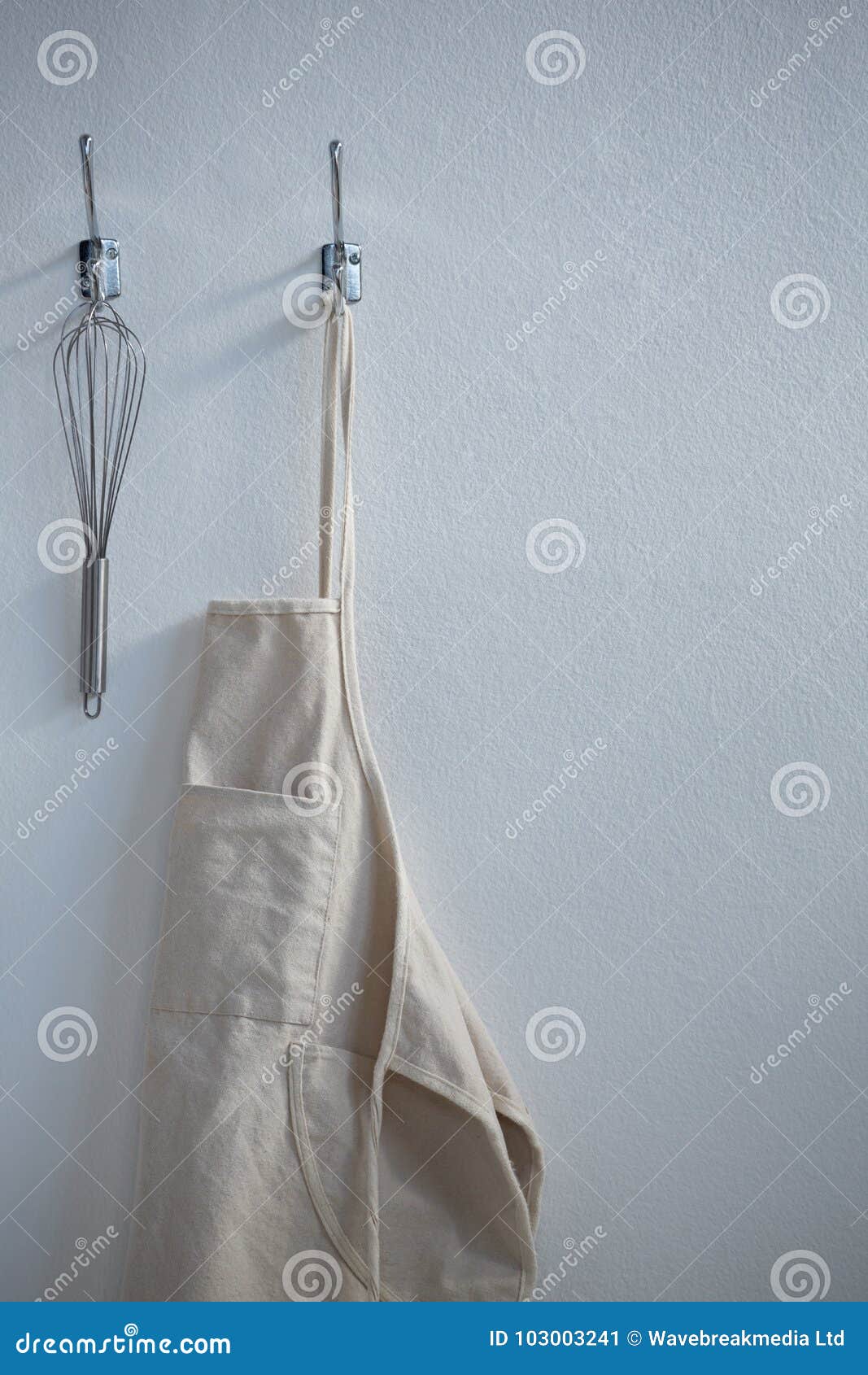 apron and whisker hanging on hook