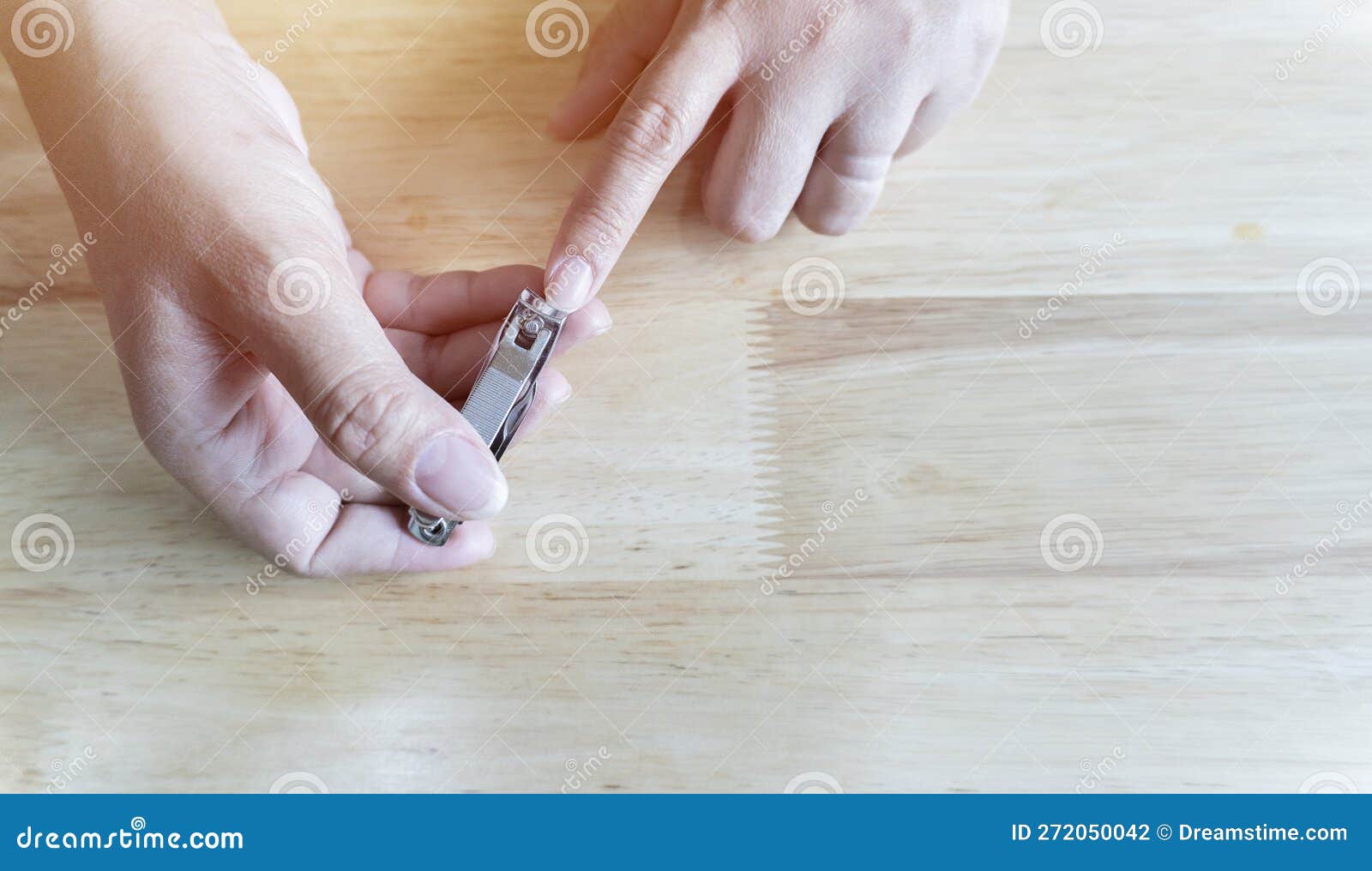 close up of asian female hands cutting fingernails. young woman clipping her nails