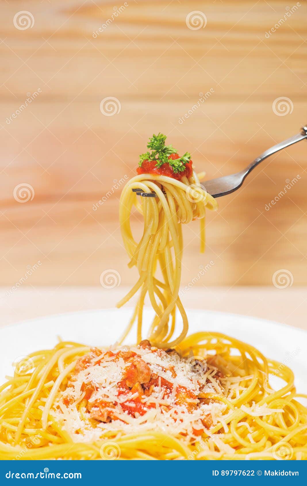 close-up of asta spaghetti with tomato sauce, olives and garnish