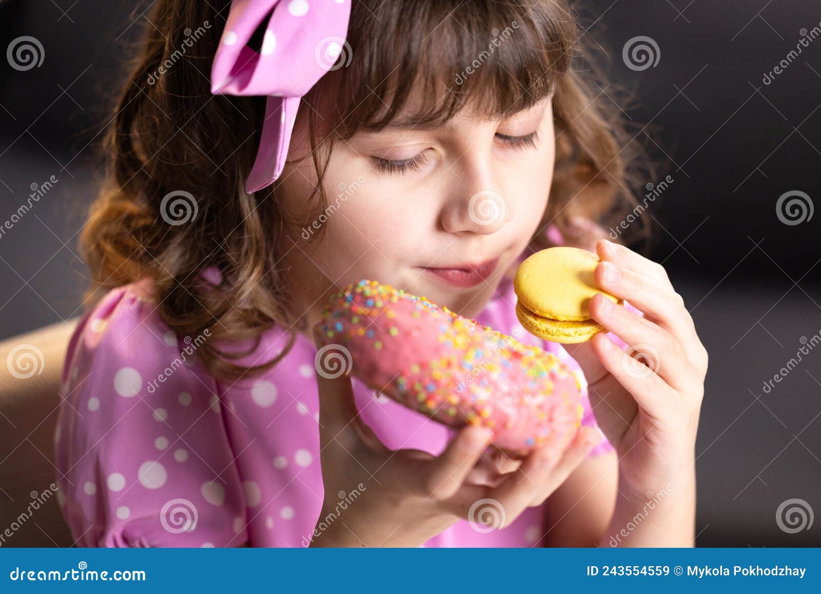 Close Up Of Attractive School Girl On Home Background Licks Her Lips Sniffing Donut And Yellow 