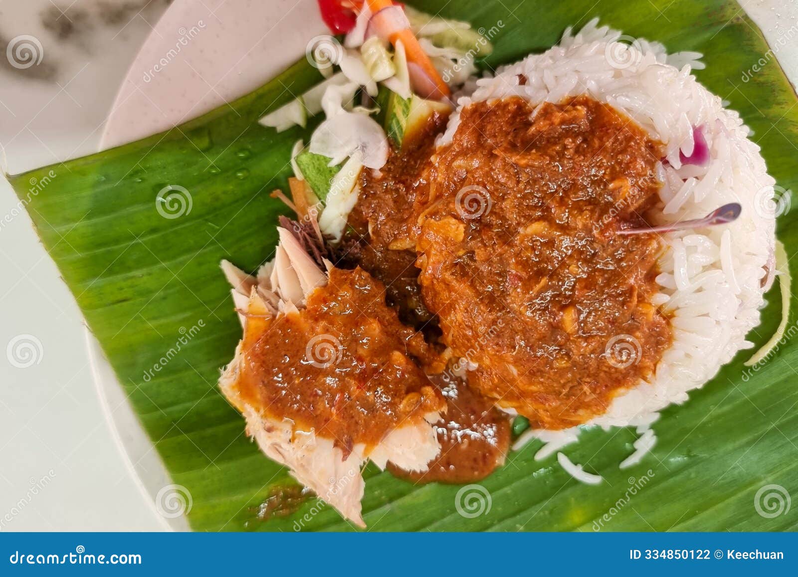 close-up on authentic simple nasi dagang, popular delicacy in terengganu served with mackerel fish fillet and gravy