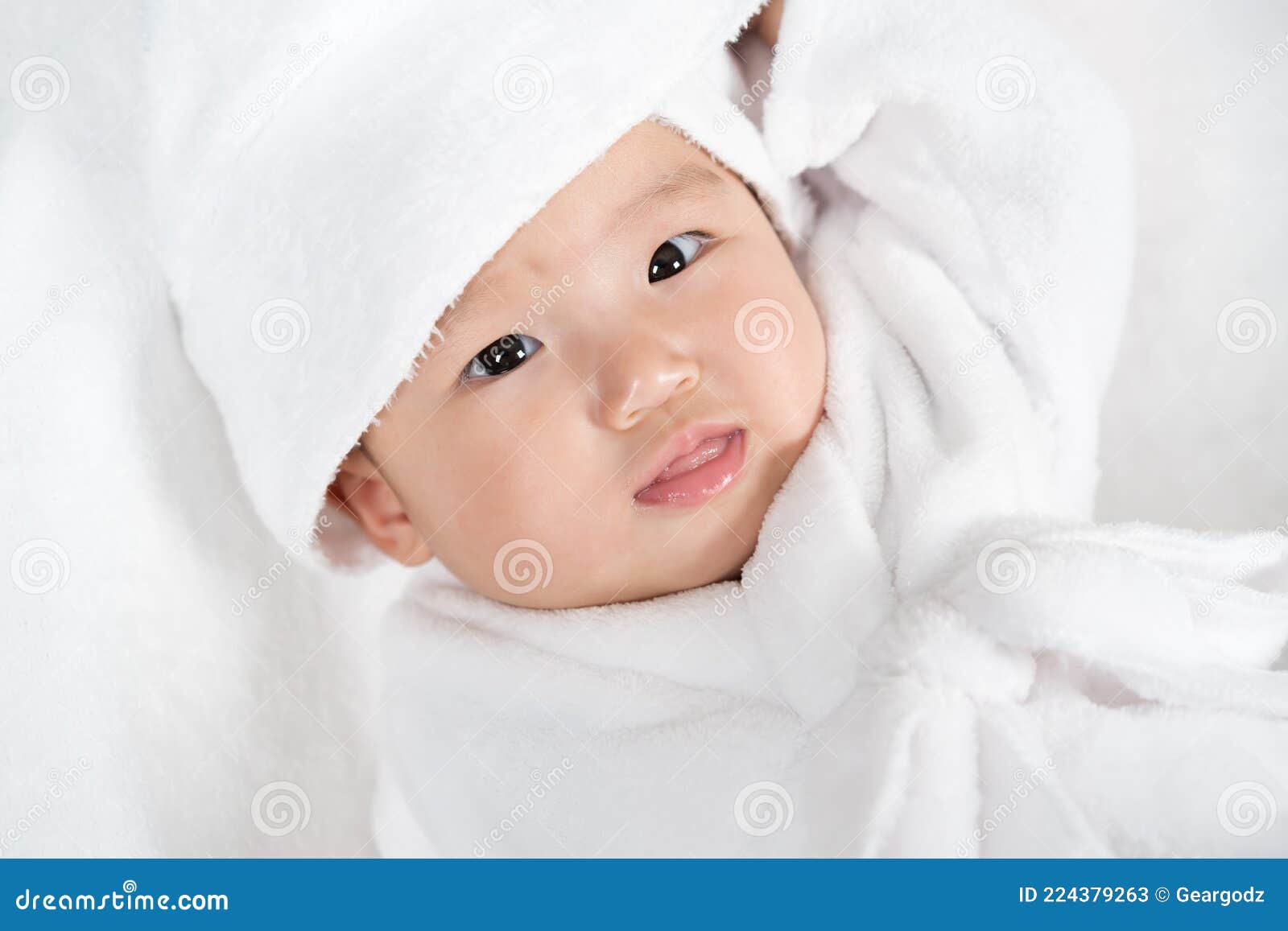 Close Up Baby in Soft Bathrobe on Bed Stock Image Image of looking