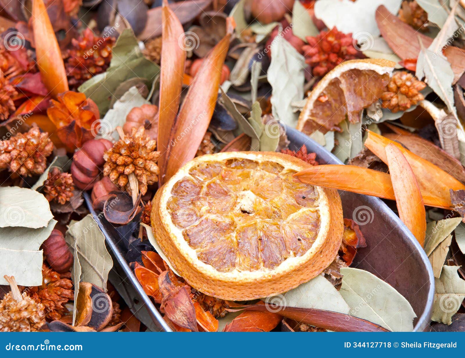 background of sliced dehydrated oranges, bay leaves and cinnamon sticks
