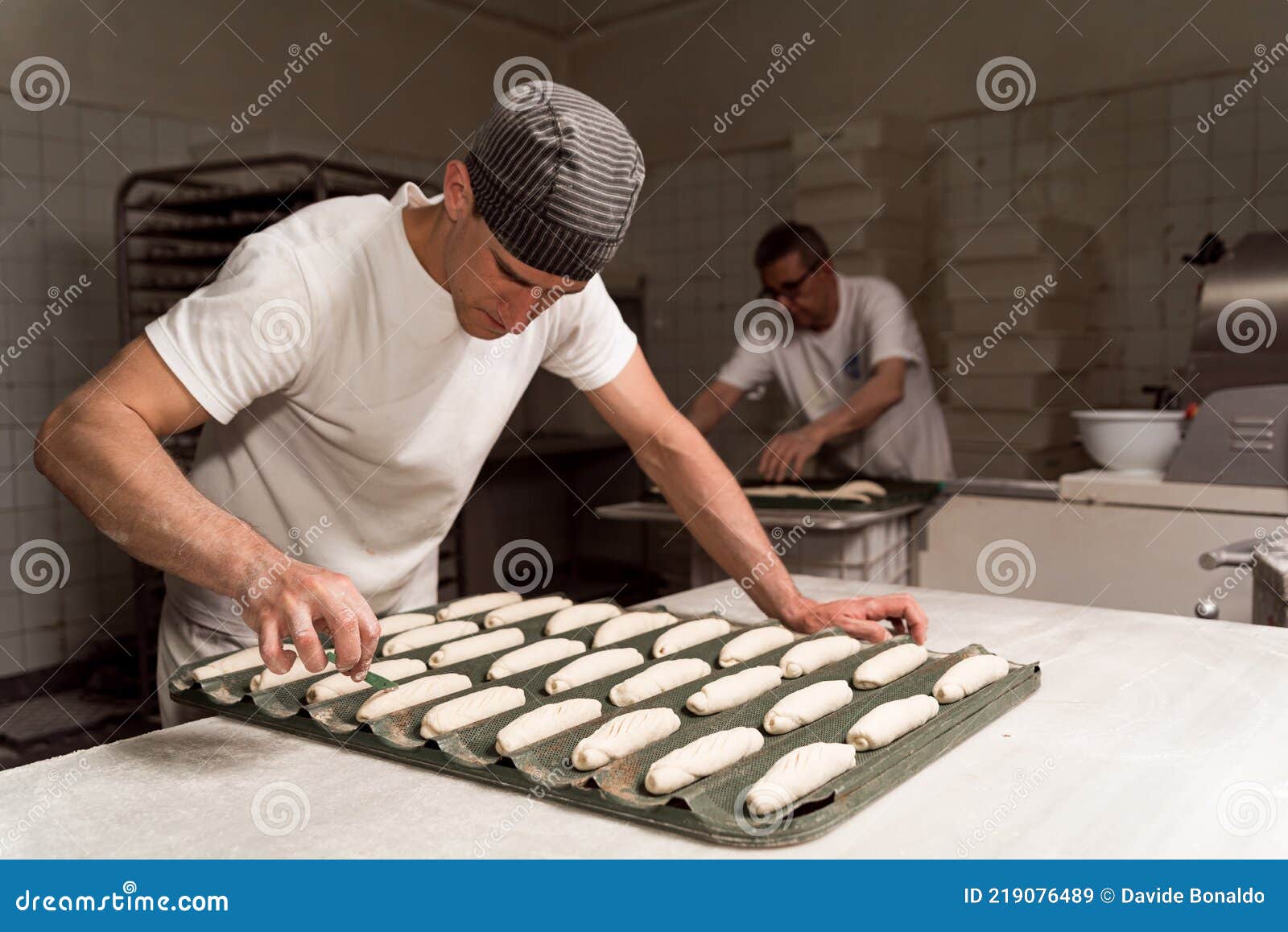 Close Up of Baker Cutting and Decorating Fresh Bread Dough before Baking it in the Oven