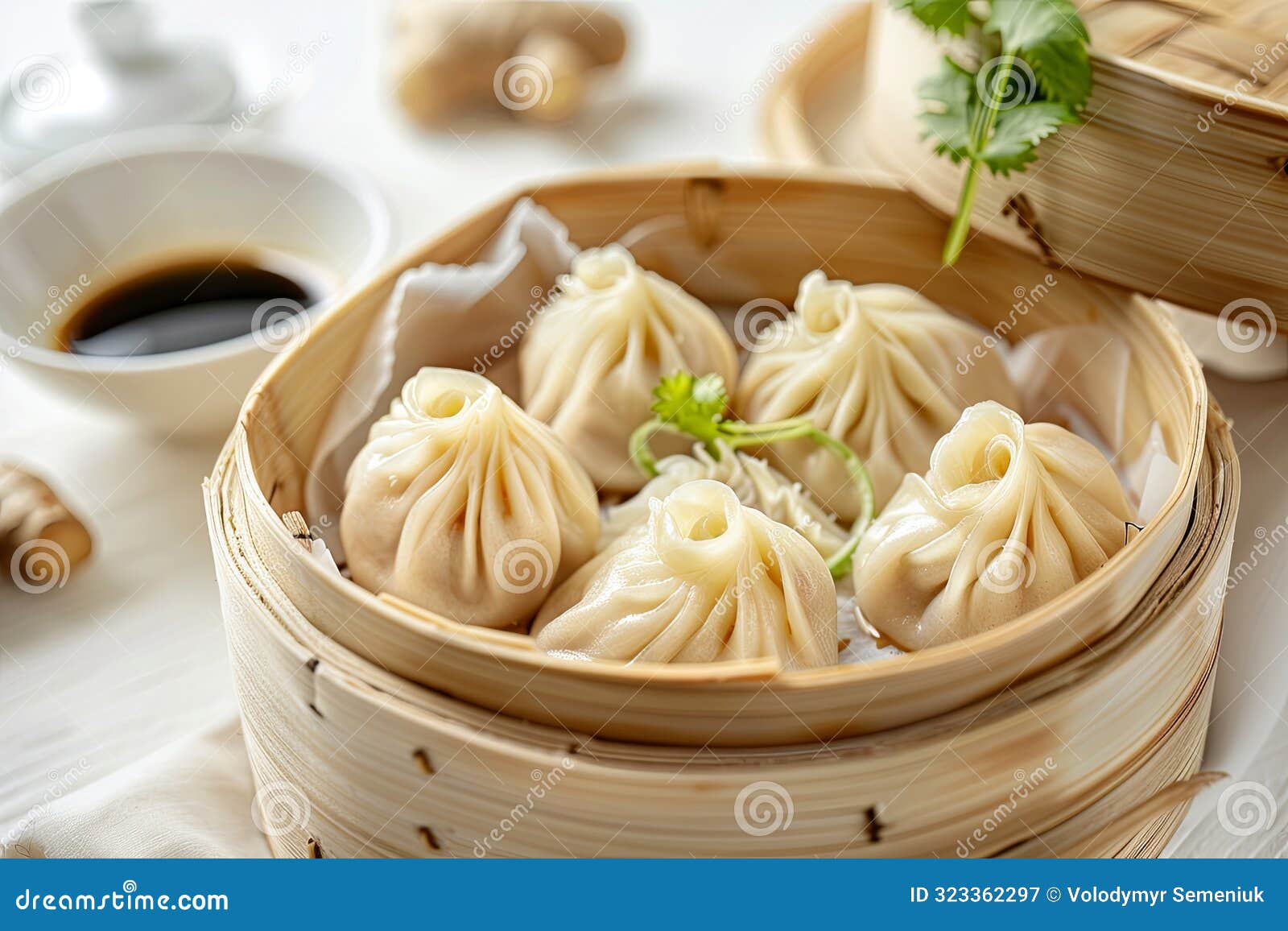steamed xiao long bao soup dumplings in a bamboo basket
