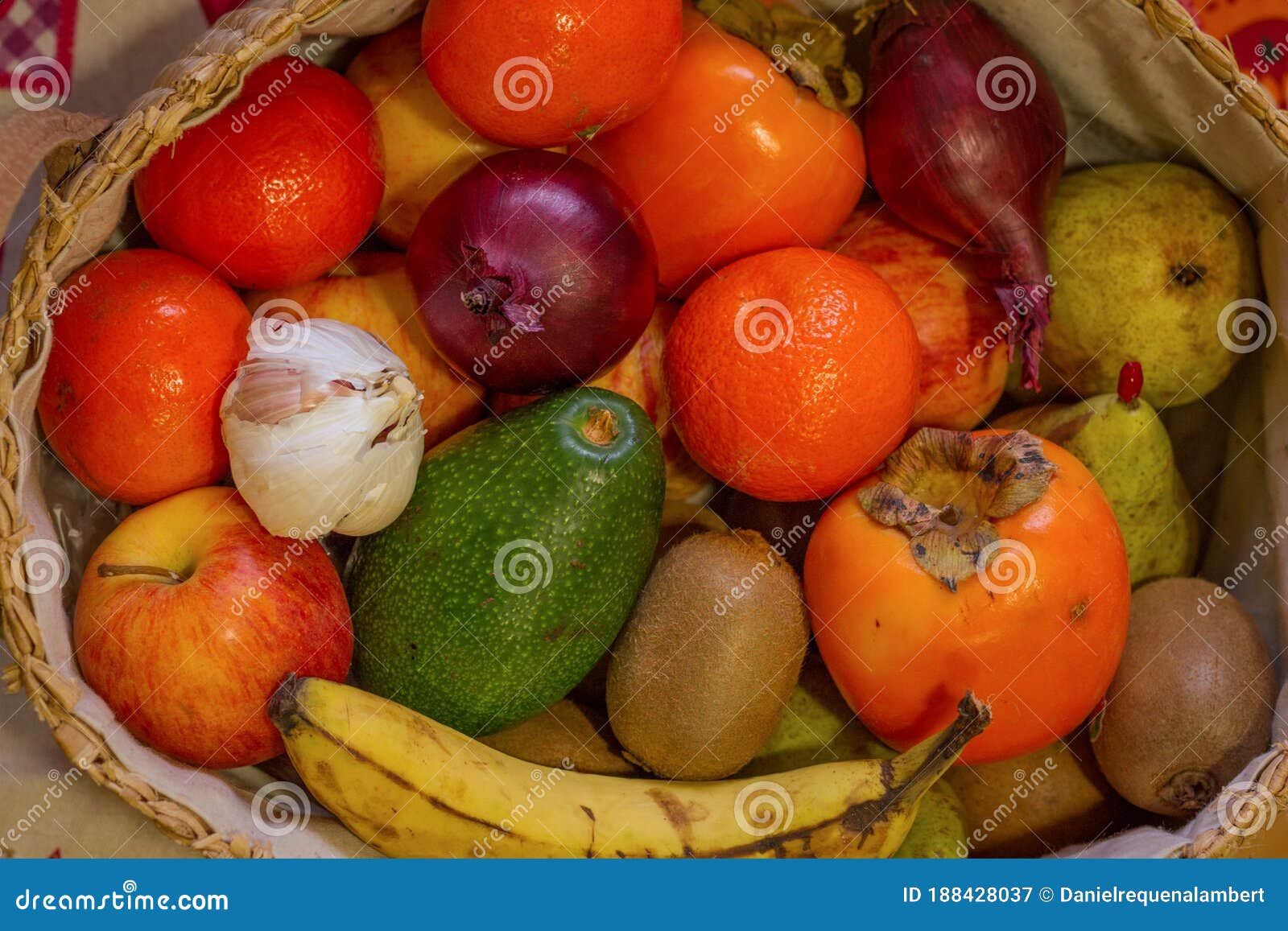 close up view of basquet full of fruits and a head of garlic.