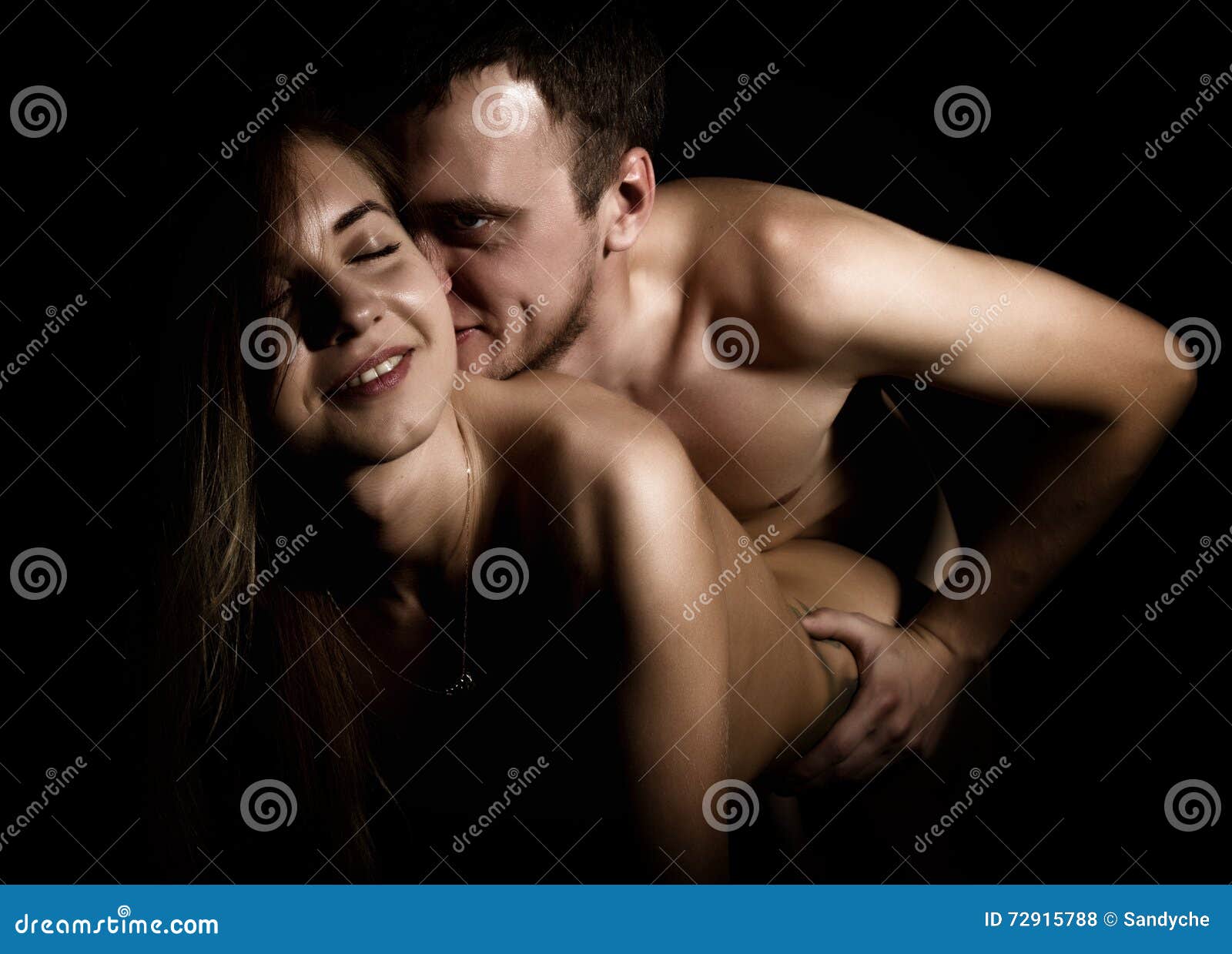 Close-Up Beautiful Young Couple, Naked Man and Woman on Black Background Stock Photo photo