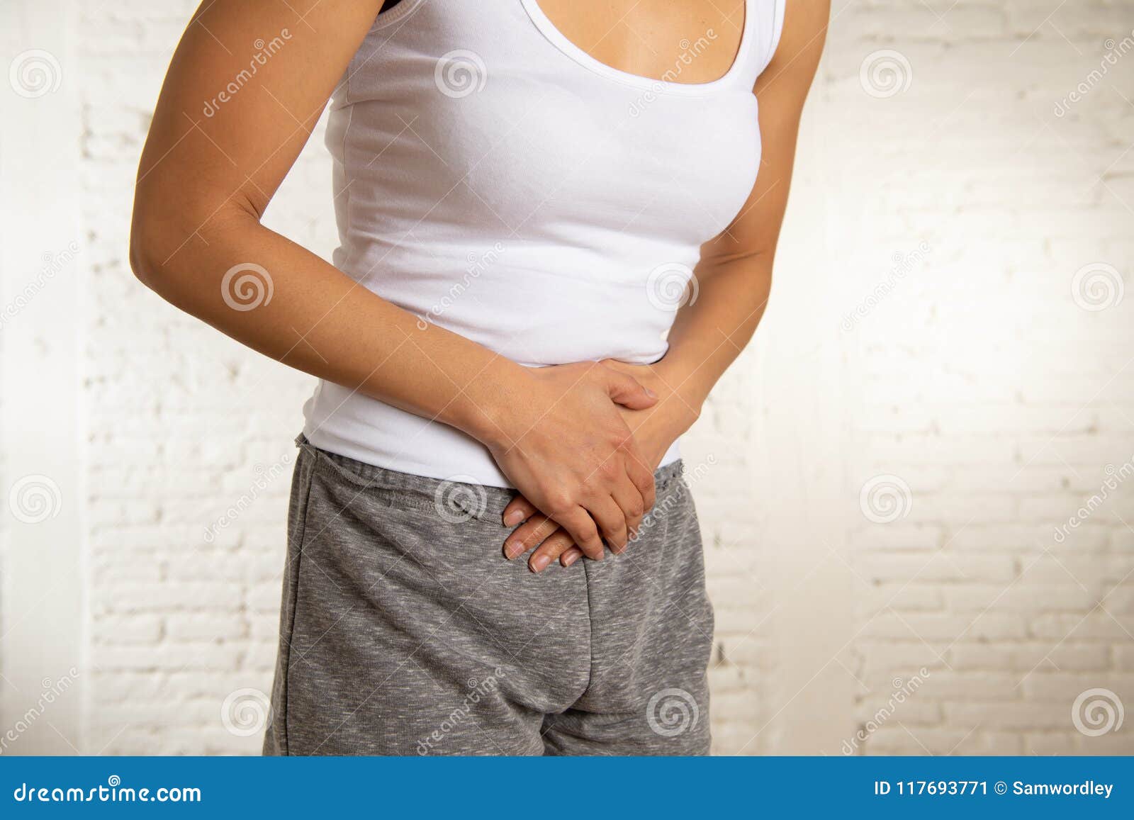 close up of beautiful woman body suffering from stomachache, period pain and menstrual cramps