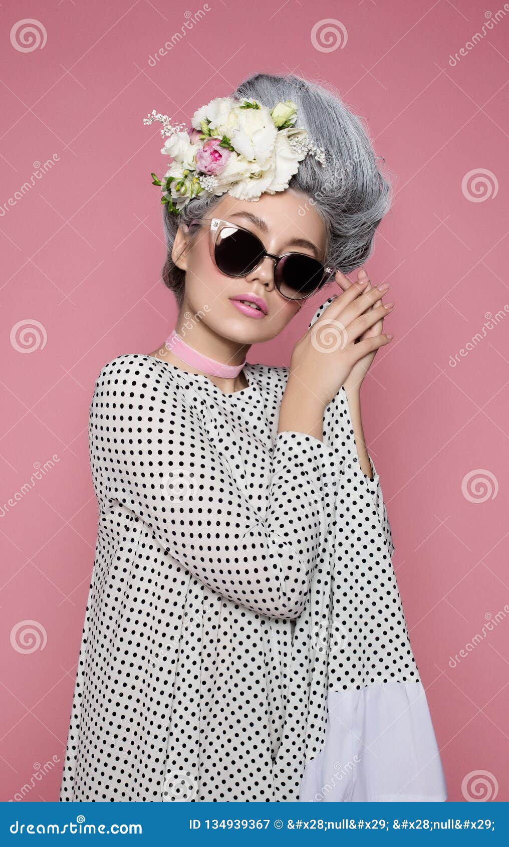 close up beauty portrait in barocco style in polka-dot dress. fashion bright pink studio background