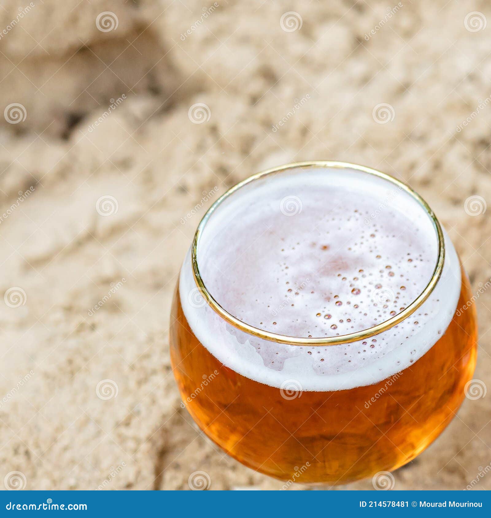 a close-up of a beer cup on the sand
