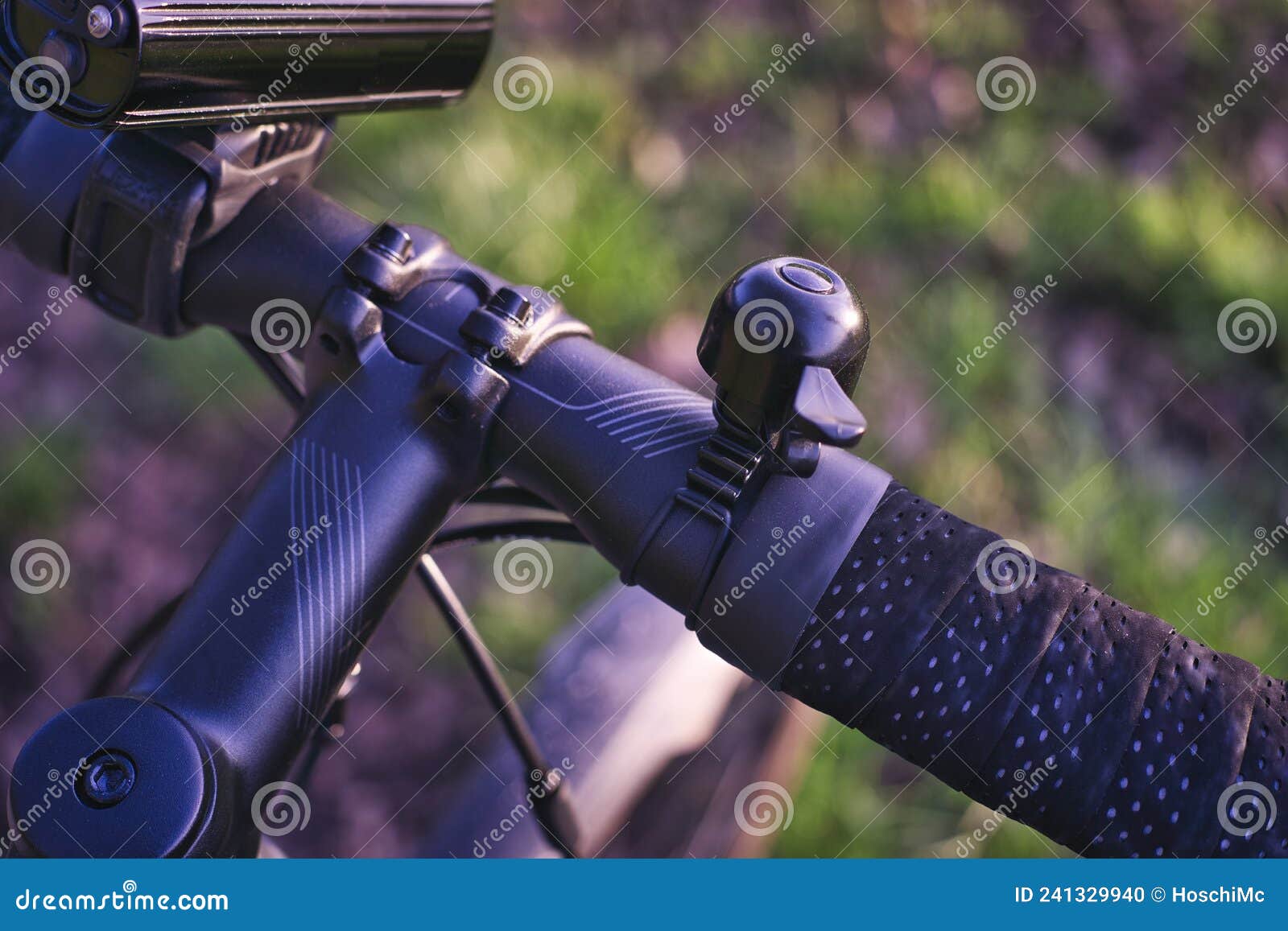 Close Up of Bicycle Handlebar with Light and Bell Stock Photo Image