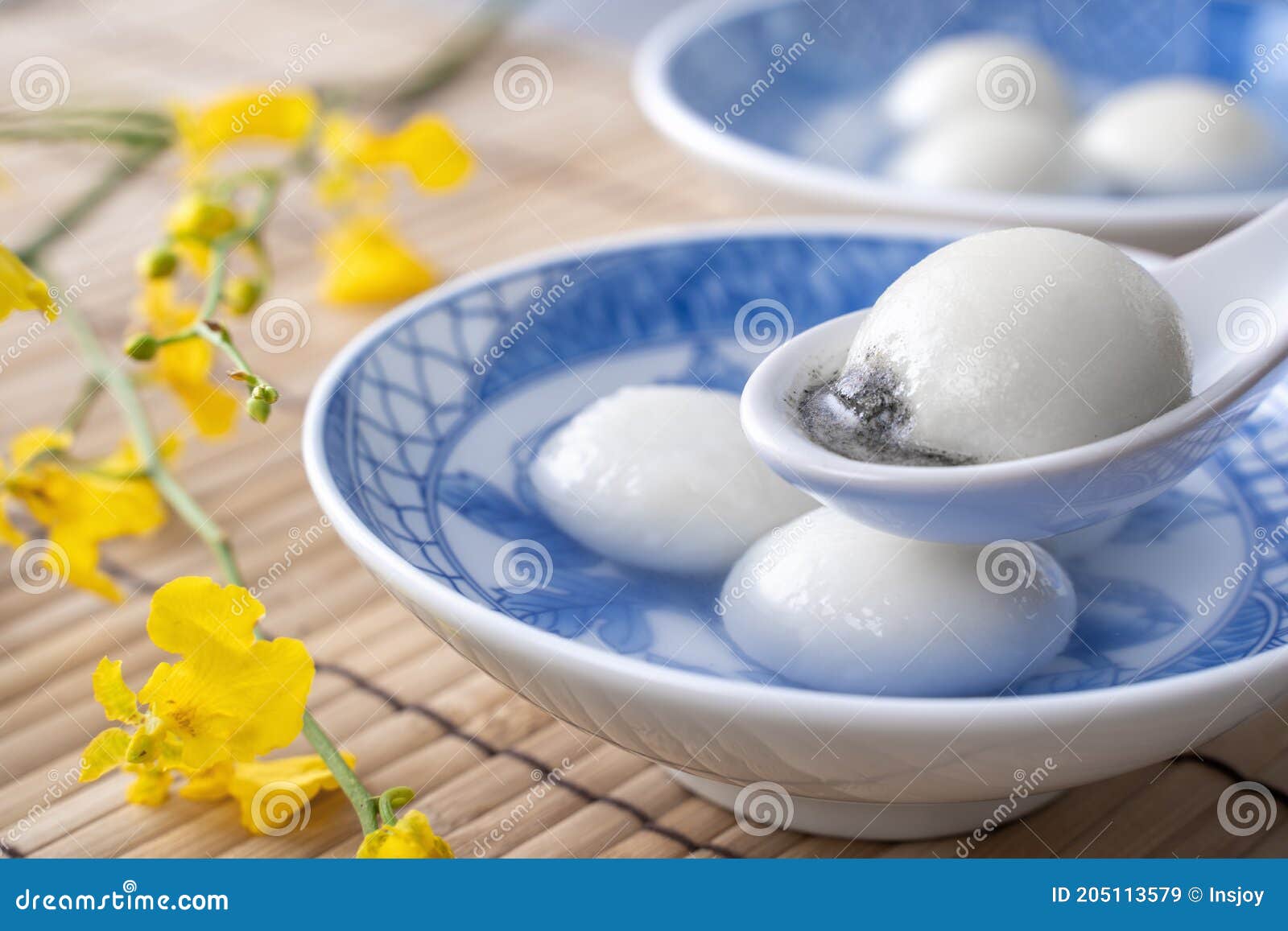 close up of tangyuan in a bowl on gray table, food for winter solstice