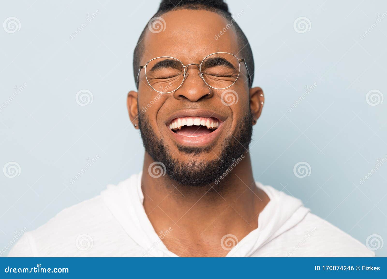 close up of black man laugh with white toothy smile