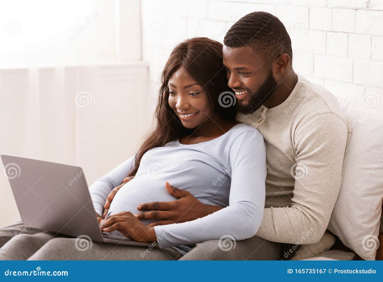 Close Up Of Black Pregnant Couple Using Laptop At Home