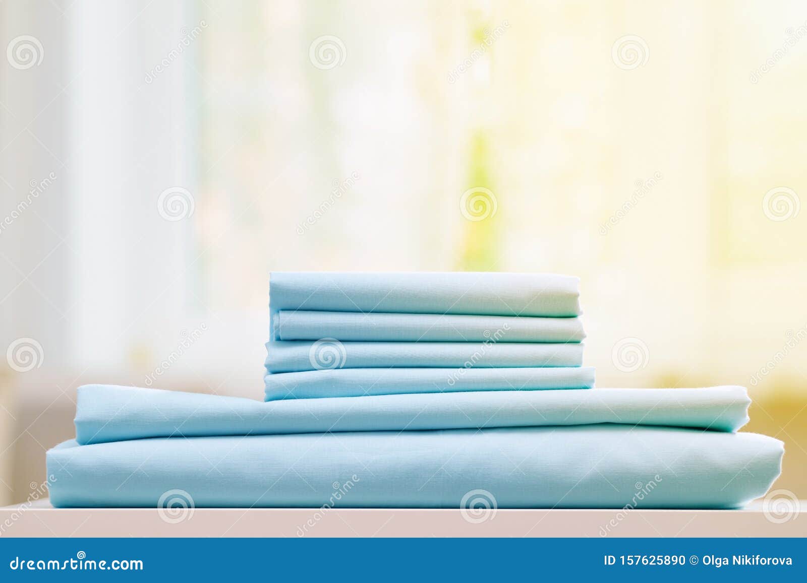 Closeup of Blue Clean Bedding on a Blurred Background. a Stack of