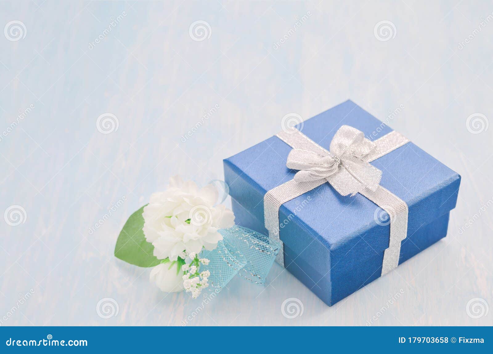 Blue Gift Box With Silver Ribbon Bow And Jasmine Flower