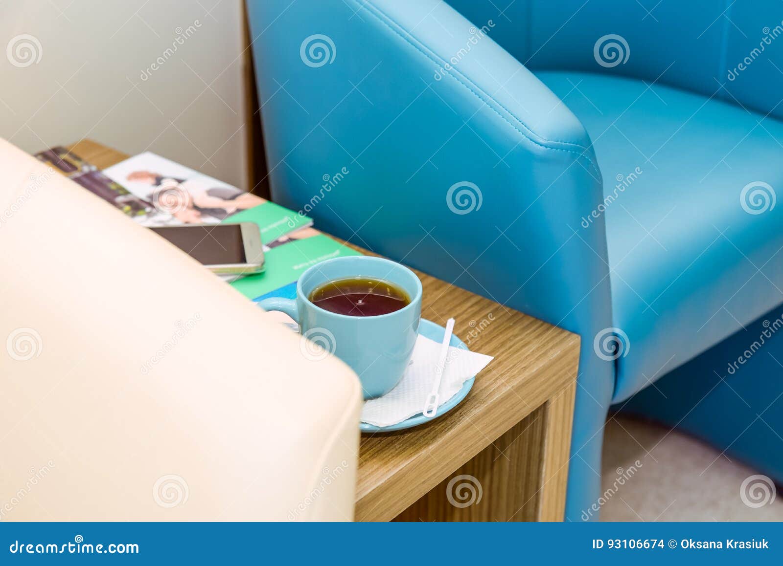 Close Up Blue and Ivory Chairs and a Cup of Coffee on the Table at