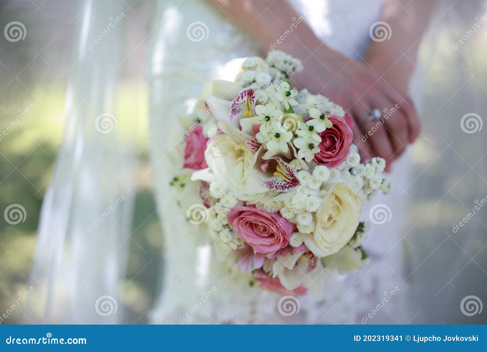 Close Up of the Bride`s Hands Holding a Bouquet of Flowers. Bridal ...