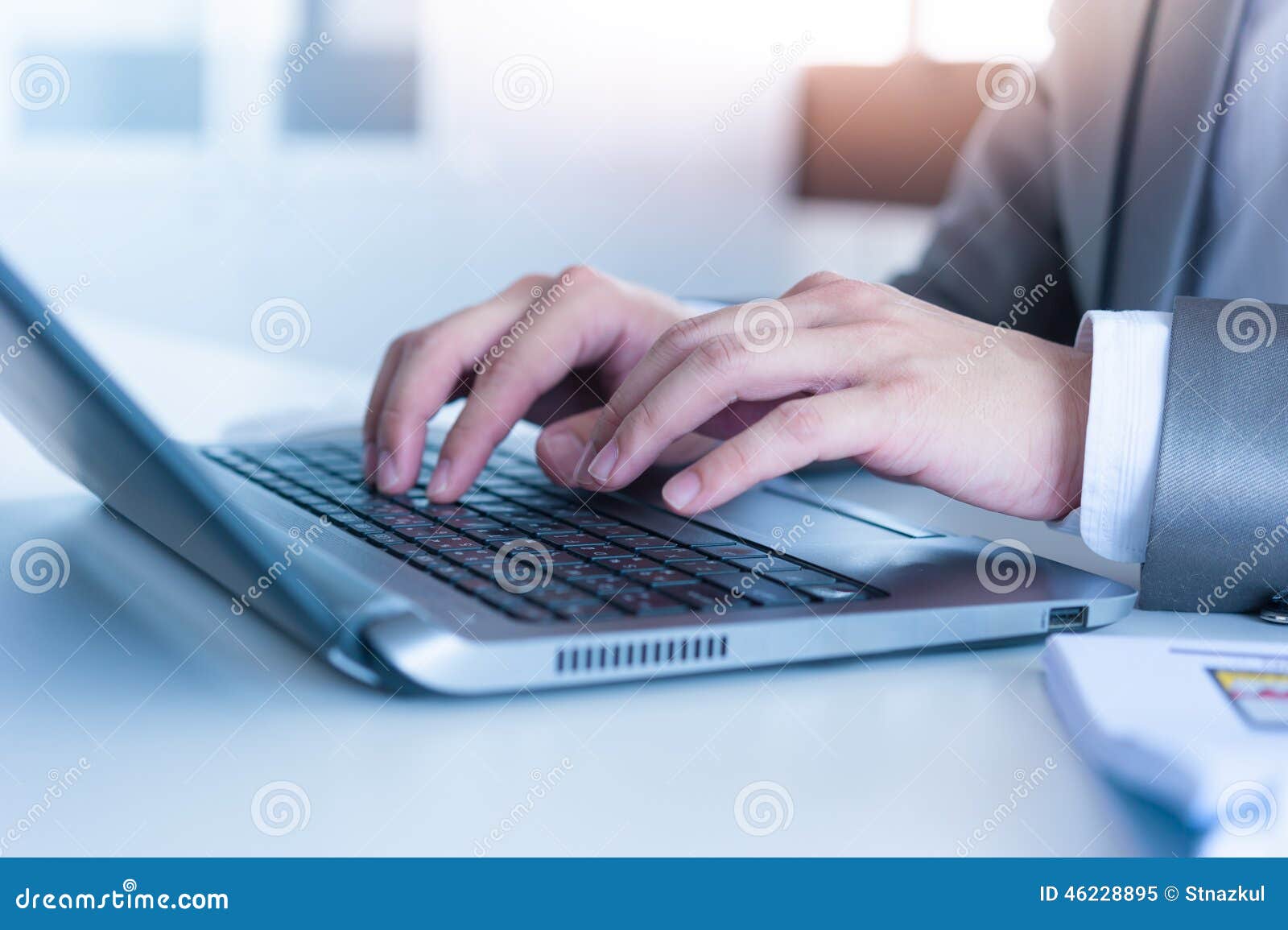 close up of business man hands typing on laptop computer