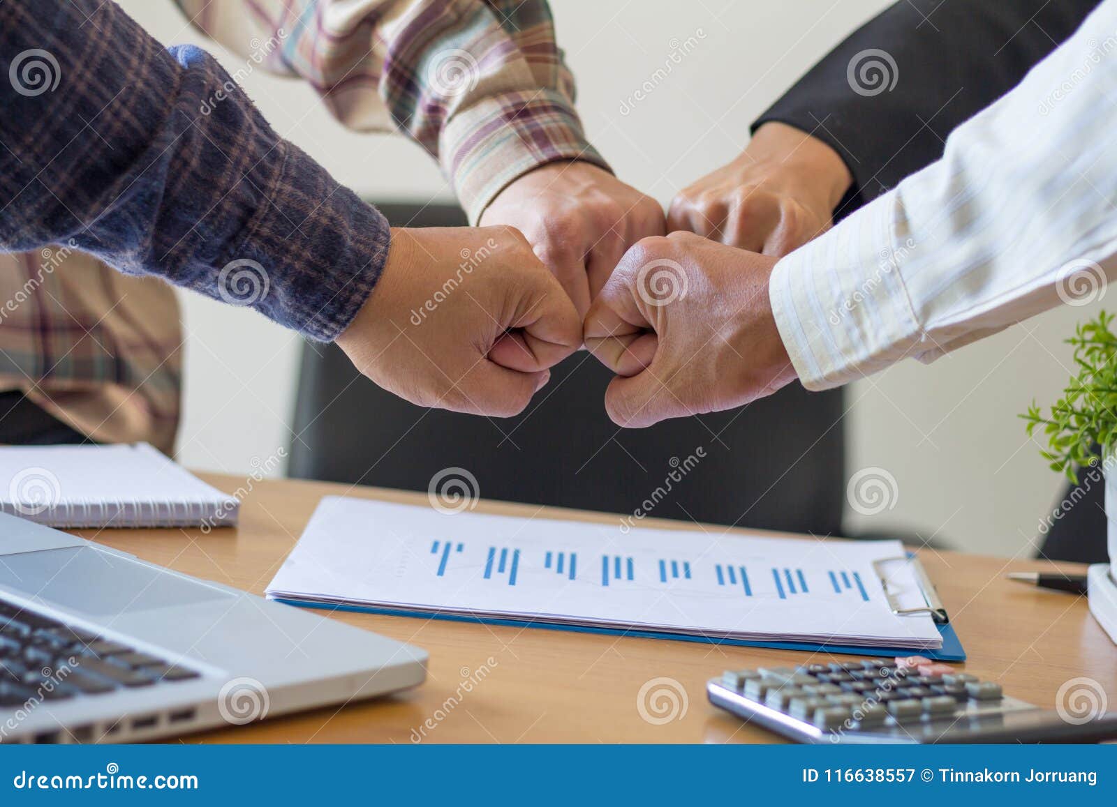 close-up of business partners making pile of hands at meeting,team work